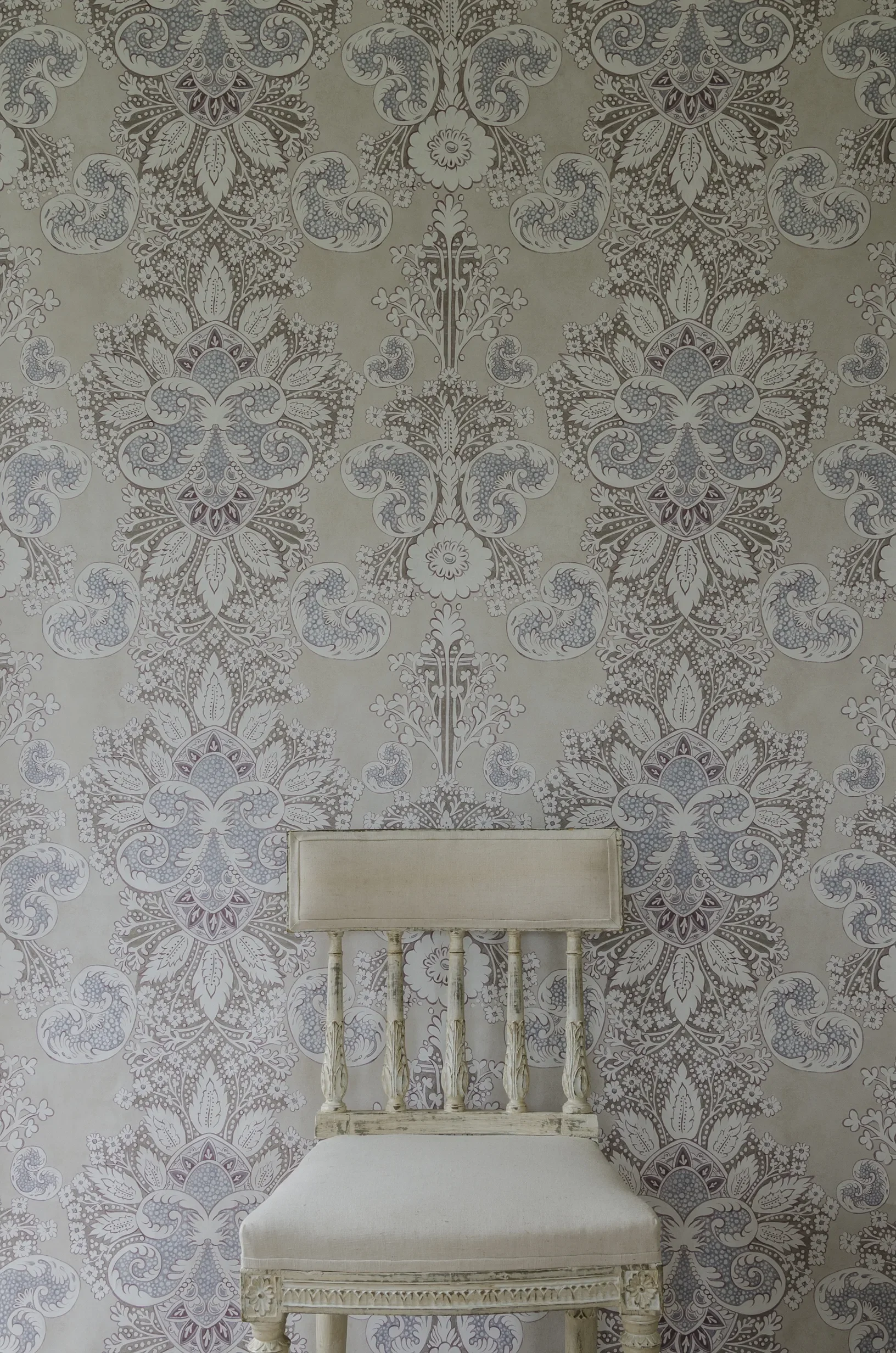 Rococo fabric by Melissa White for Lewis & Wood pictured with a chair in front.