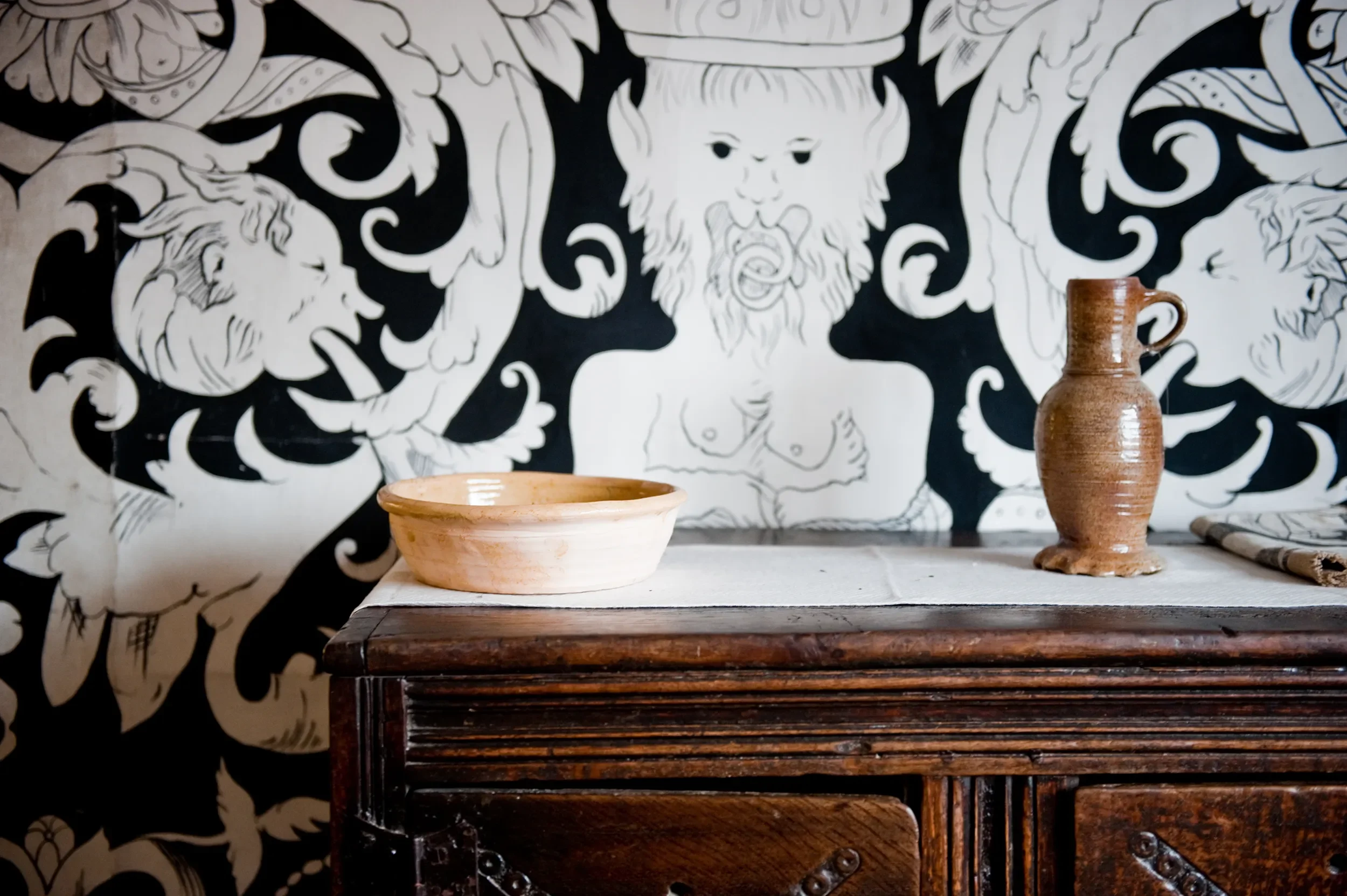 Tudor cabinet set with vase against Melissa White's painted cloths in Shakespeare's Birthplace Museum.