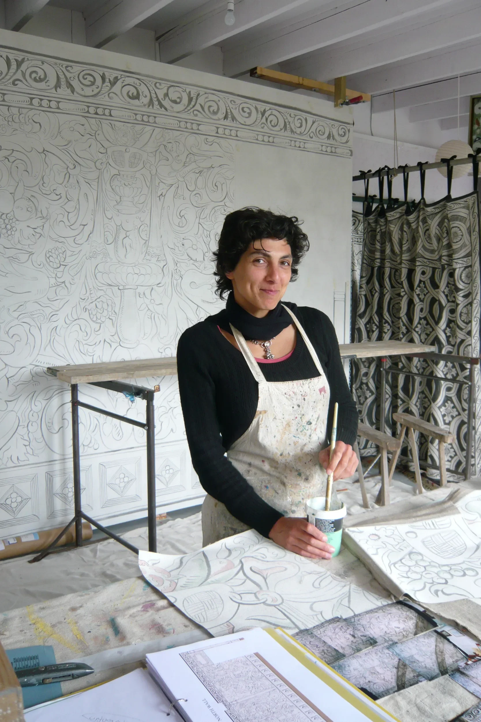 Melissa White pictured working in front of her largescale multivine painted cloths for Stiffkey Old Hall, Norfolk.