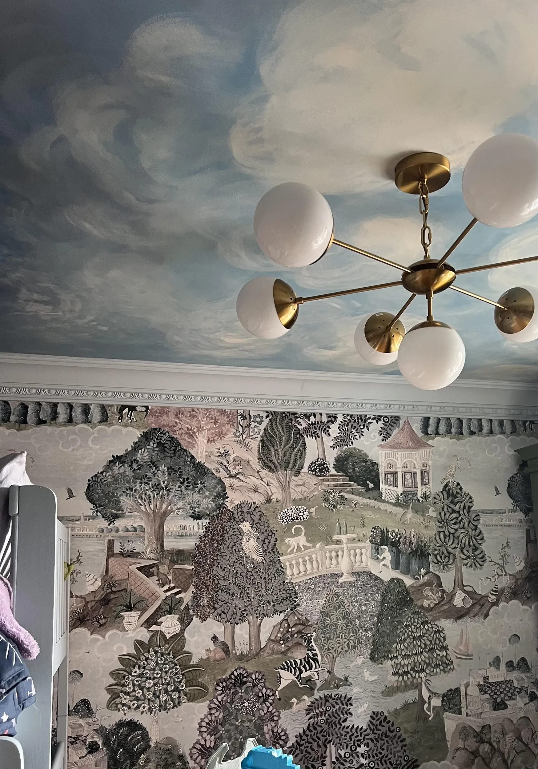 Emily's Garden wallpaper by Melissa White pictured in a room with a painted sky ceiling and modern chandelier.