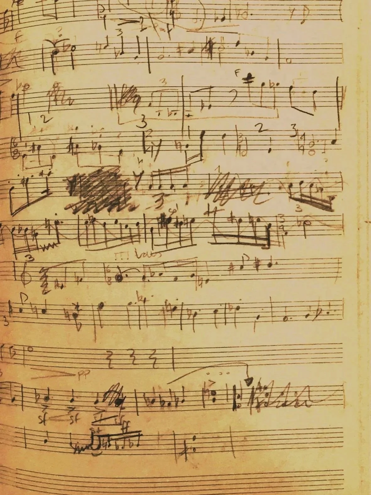 Handwritten sheet music on aged paper, with notes, annotations, and corrections.