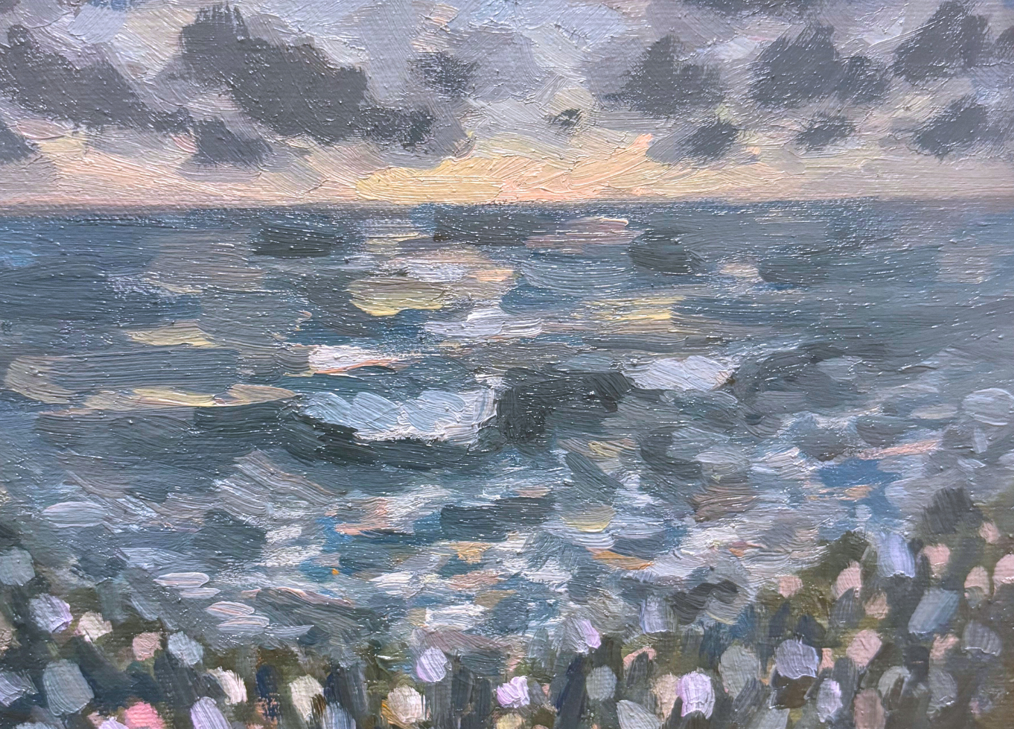 Oil painting of a seascape at sunset showing the ocean with waves in the foreground, dark clouds above, and the setting sun on the horizon in Puerto Escondido, Mexico..