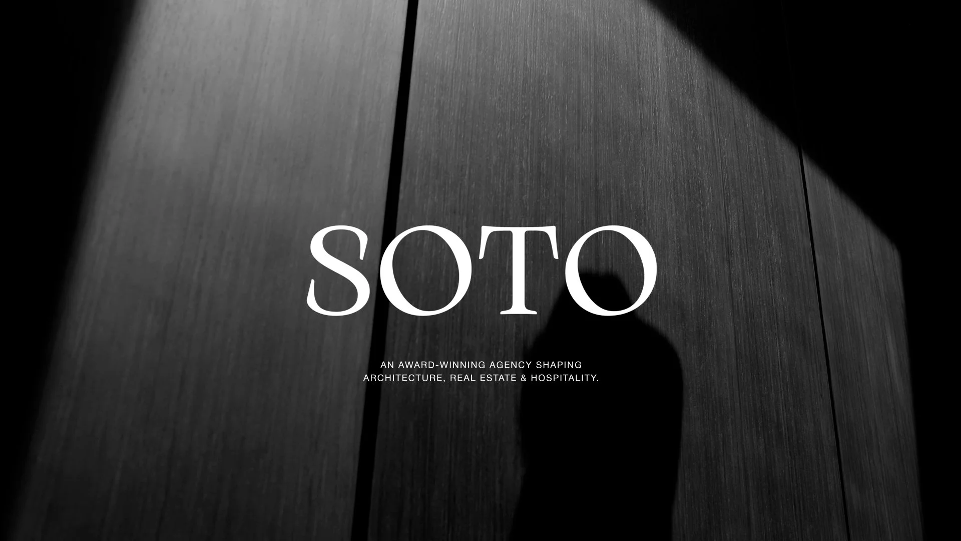 Black and white image with the text "SOTO" in large font and a shadow silhouette of a person. Smaller text reads "An award-winning agency shaping architecture, real estate & hospitality."