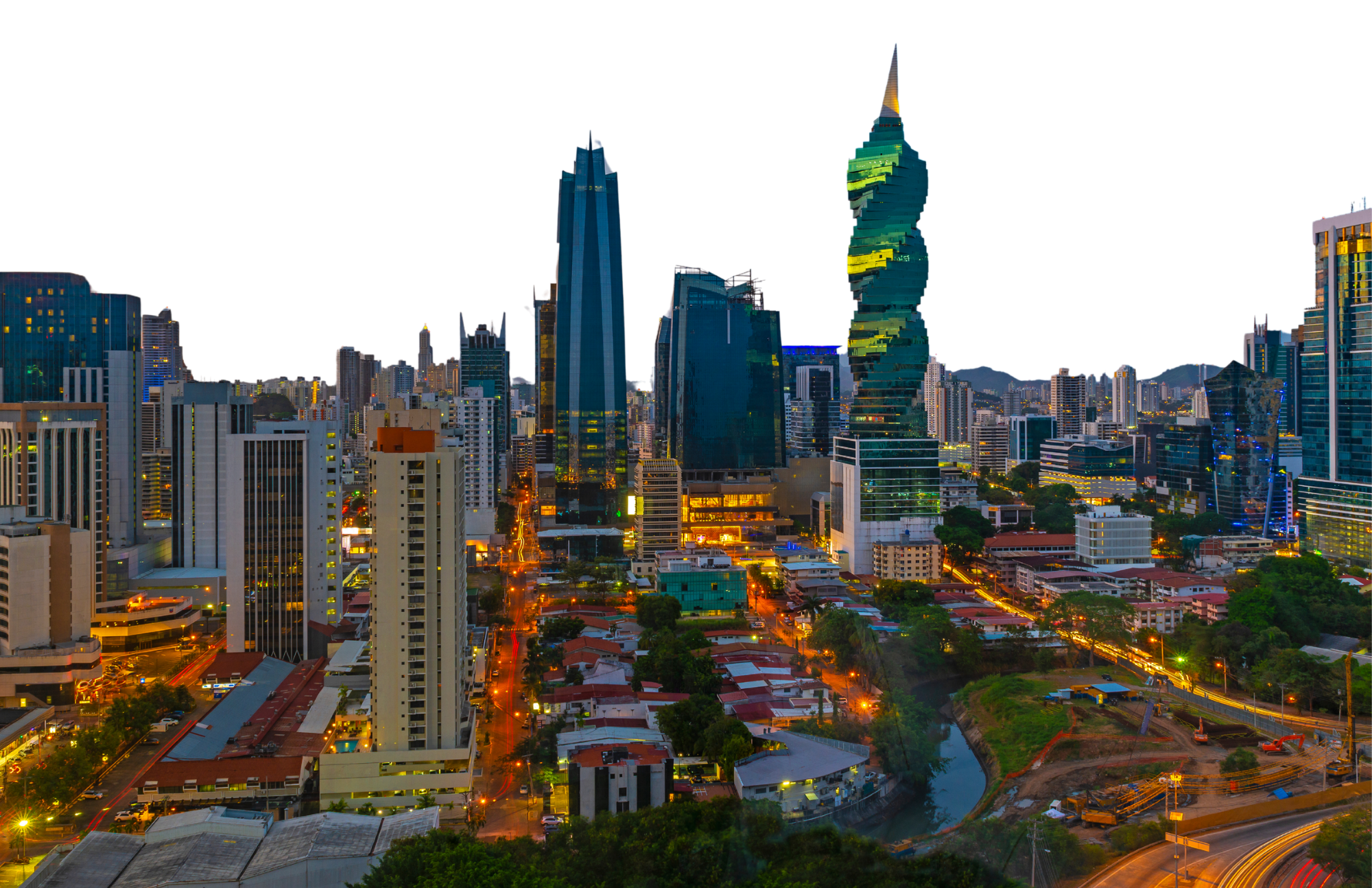 A cityscape at dusk with illuminated skyscrapers, a river, and streets with light trails from moving vehicles.