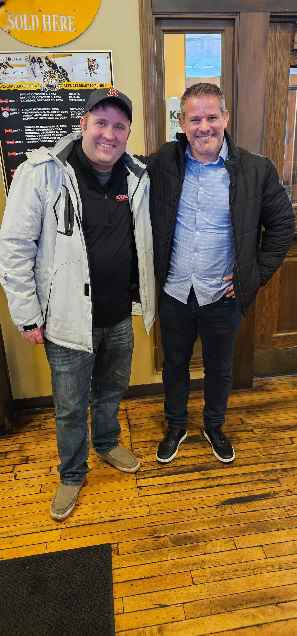 Mark and Adam Kinzinger, former Republican member of the U.S. House of Representatives, smiling with their arms around each other.