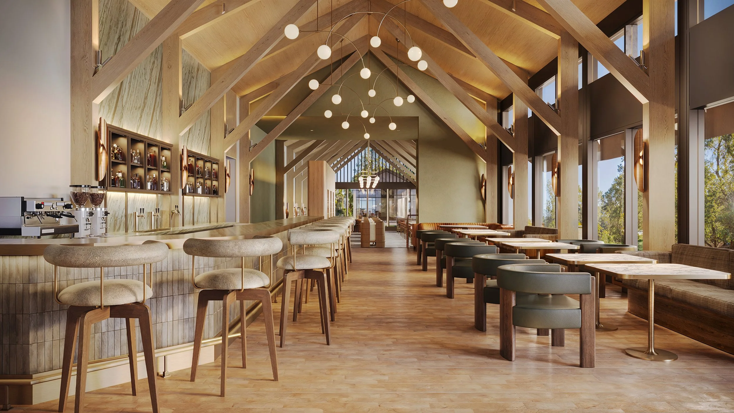 Interior of a modern restaurant or café with a high, vaulted wooden ceiling, large windows, and seating including bar stools and tables. There are decorative light fixtures hanging from the ceiling and trees visible outside through the windows.