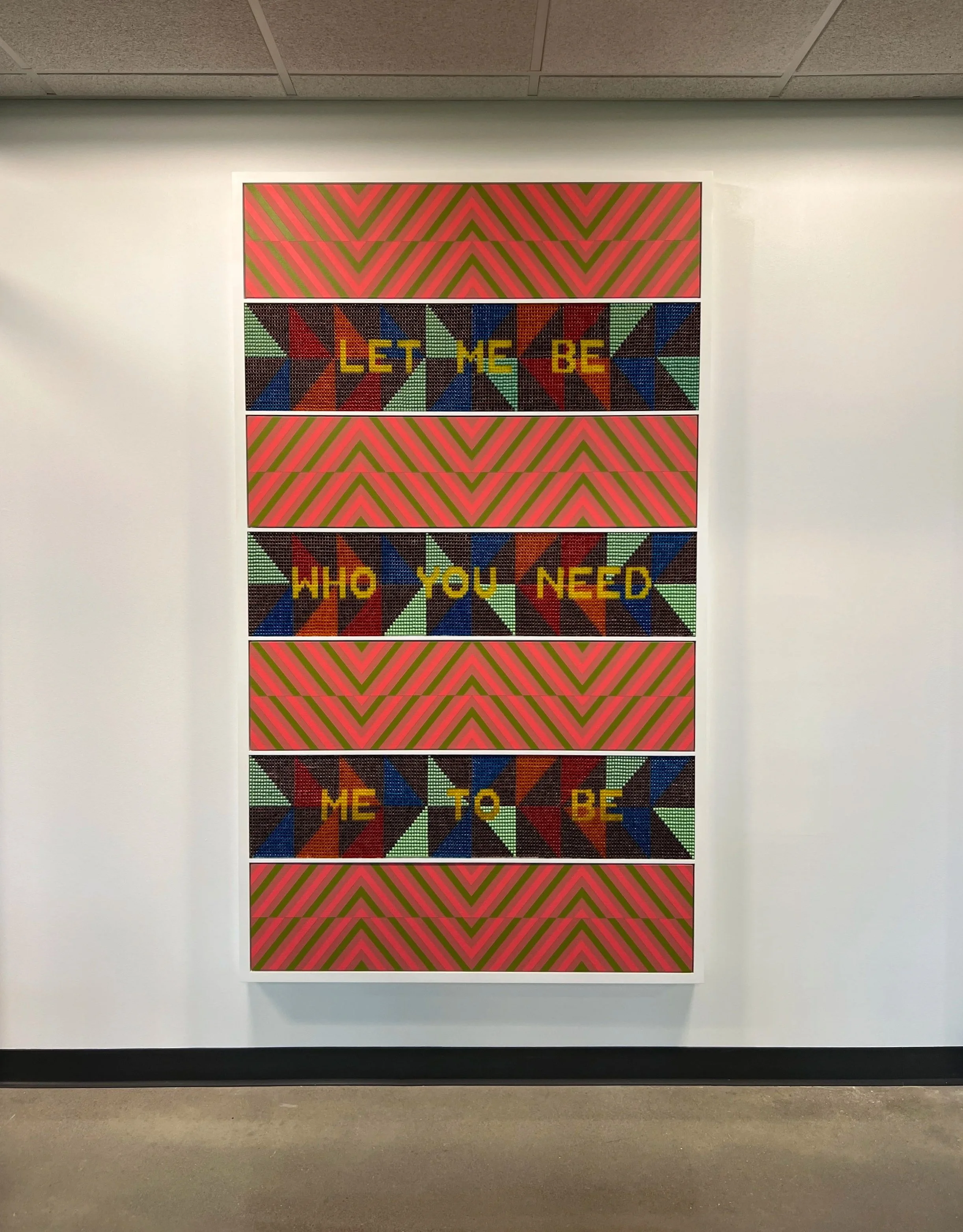 Colorful wall art with geometric patterns and words: 'LET ME BE', 'WHO YOU NEED', 'ME TO BE'.
