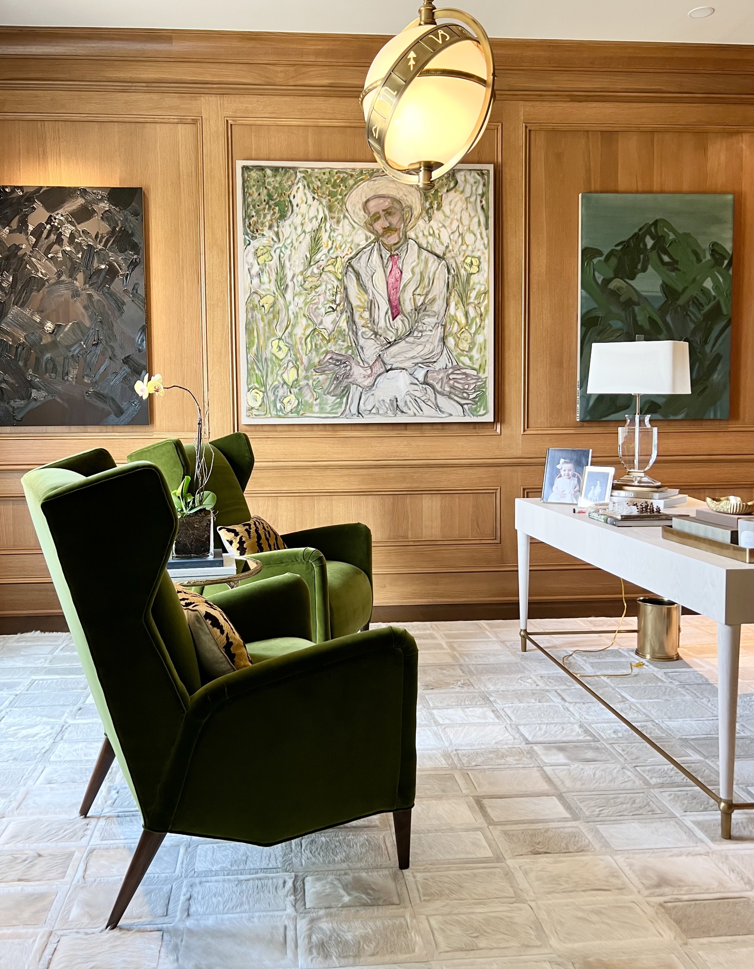 Bold Kyle bunting rug, green contemporary wingback, wood paneled office with bold contemporary art by Billy Childish and Andy Woll.