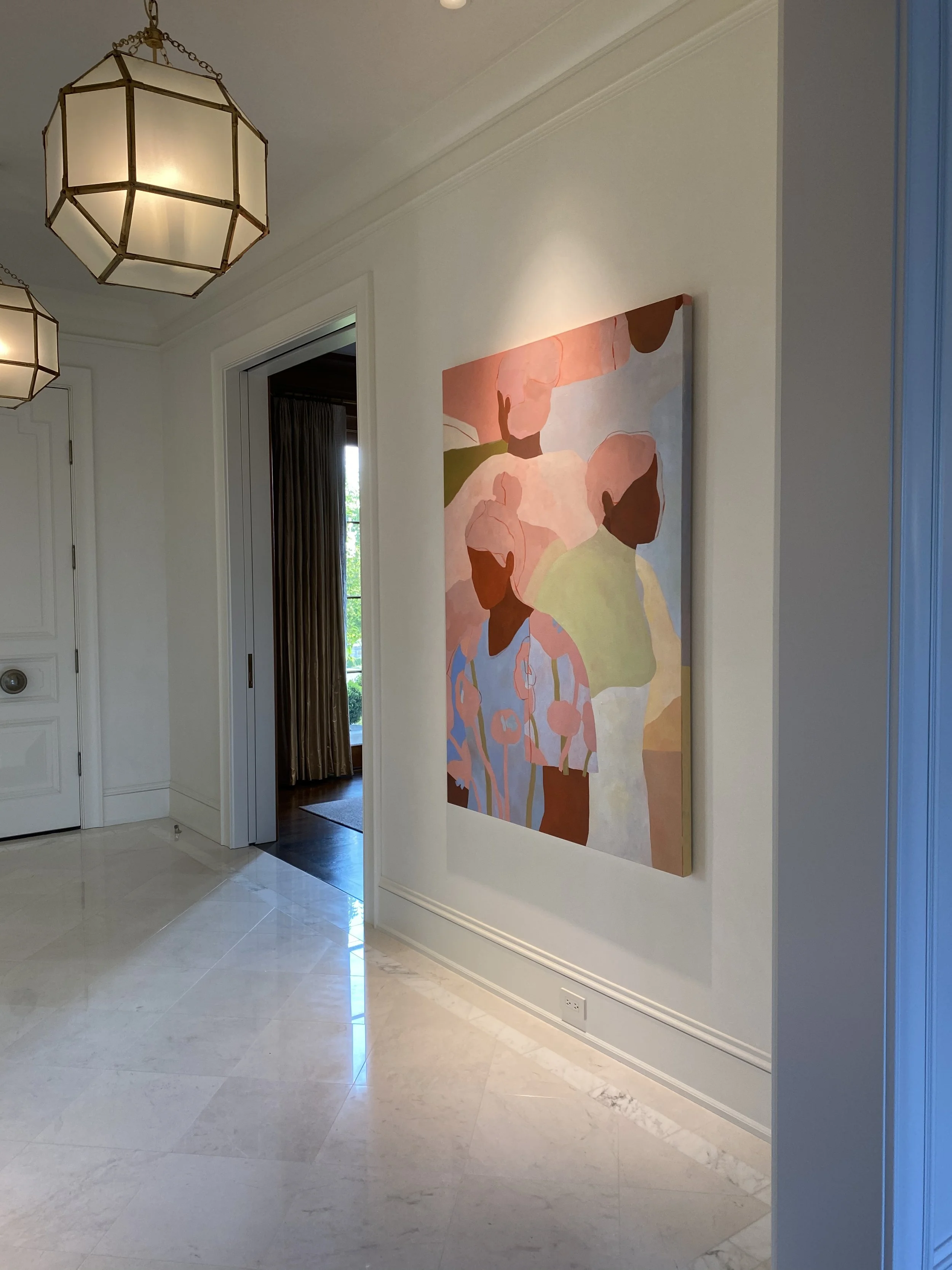 Interior shot of a hallway with a large abstract painting on the wall, ceiling lights, and a doorway with a curtain leading to another room, polished white marble floors, and white walls.
