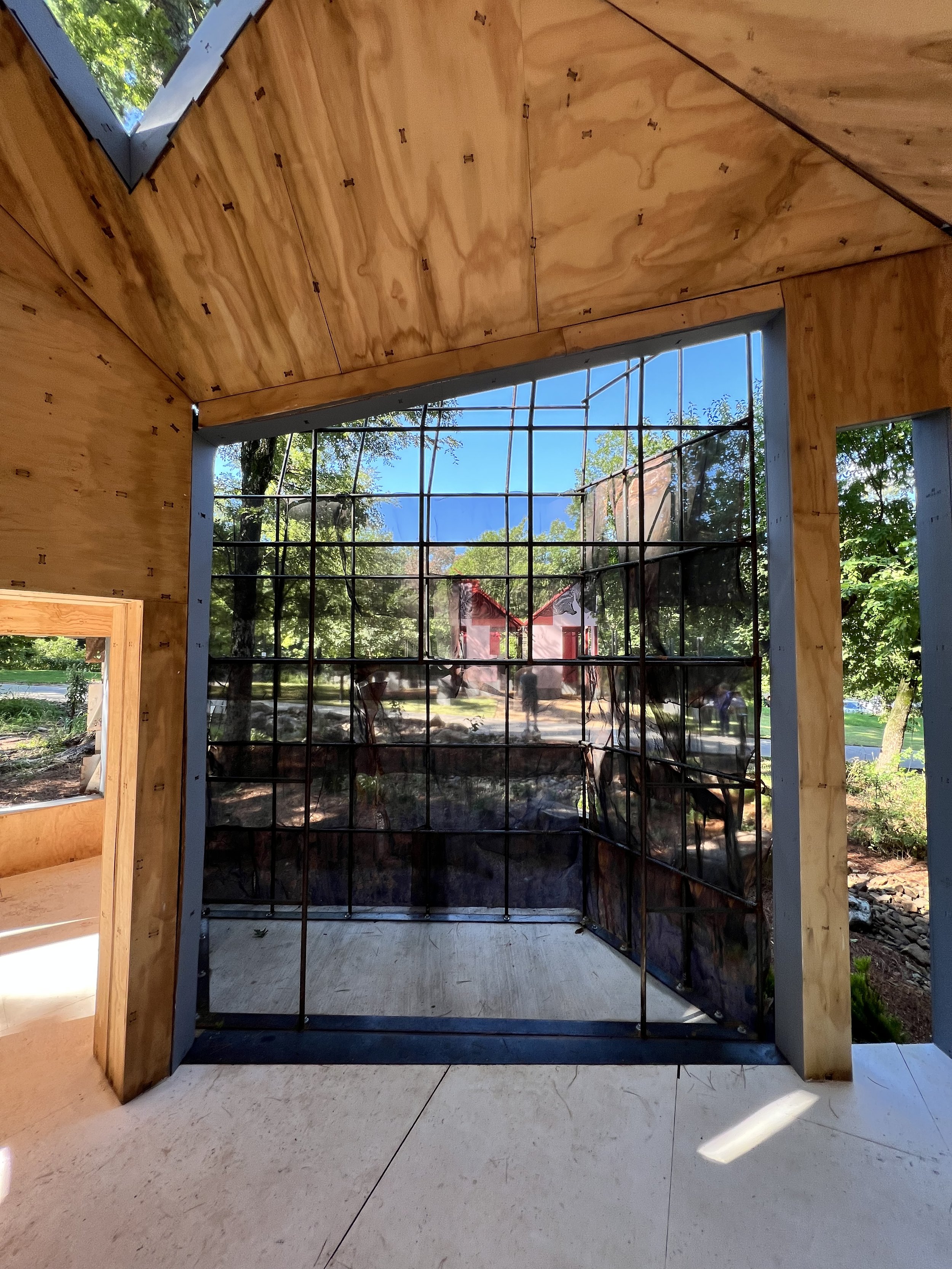 Paneled wood outlines the structure of this sculptural architectural follie underscoring the relationship between space and sky.
