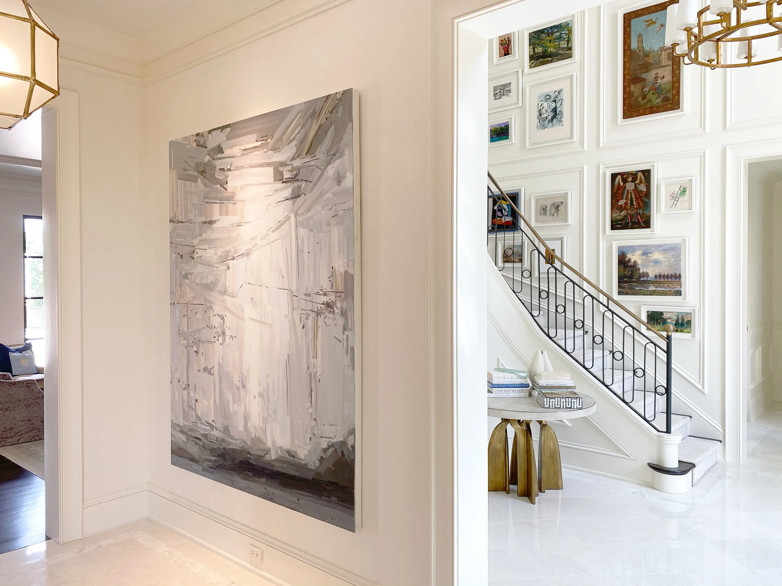 Large contemporary painting by Claire Sherman in entry way of grand traditional Austin, Texas home. Grey landscape based abstraction on cream walls, high ceilings and ornamental millwork with marble floors, Dylan Turk Art Advisor and Interior Design
