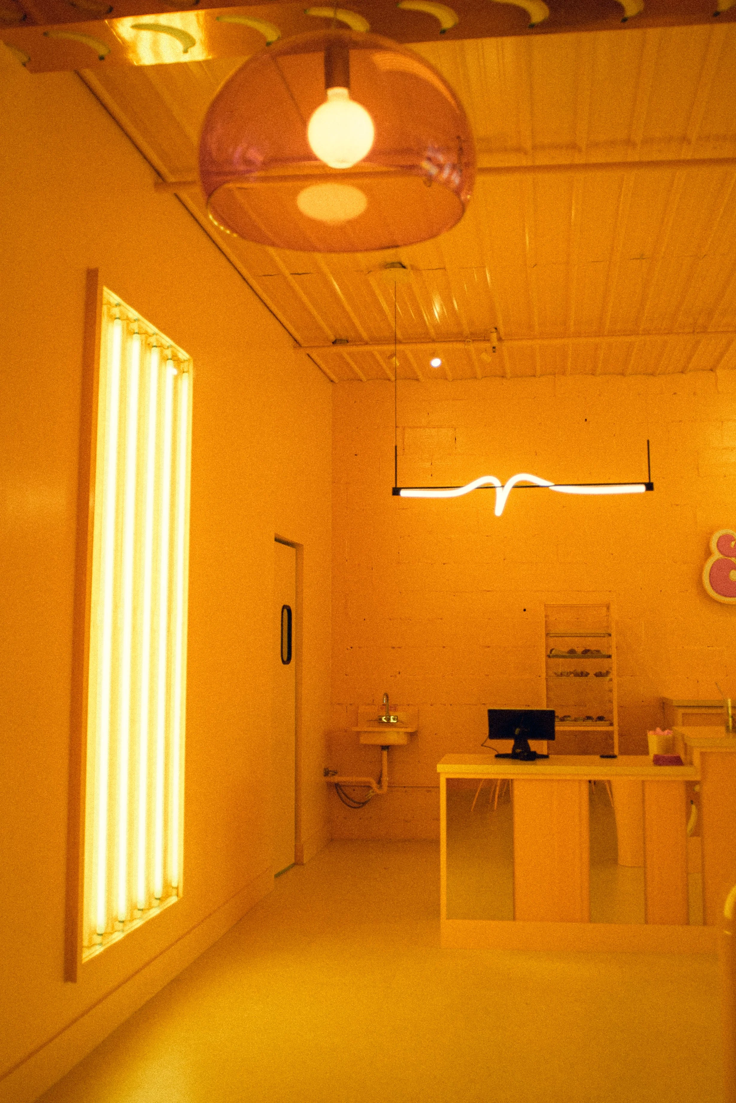 Marigold saturation, sculptural light fixtures and installations inspired by dan flavin, industrial hospitality space bold in color and pattern and concept.