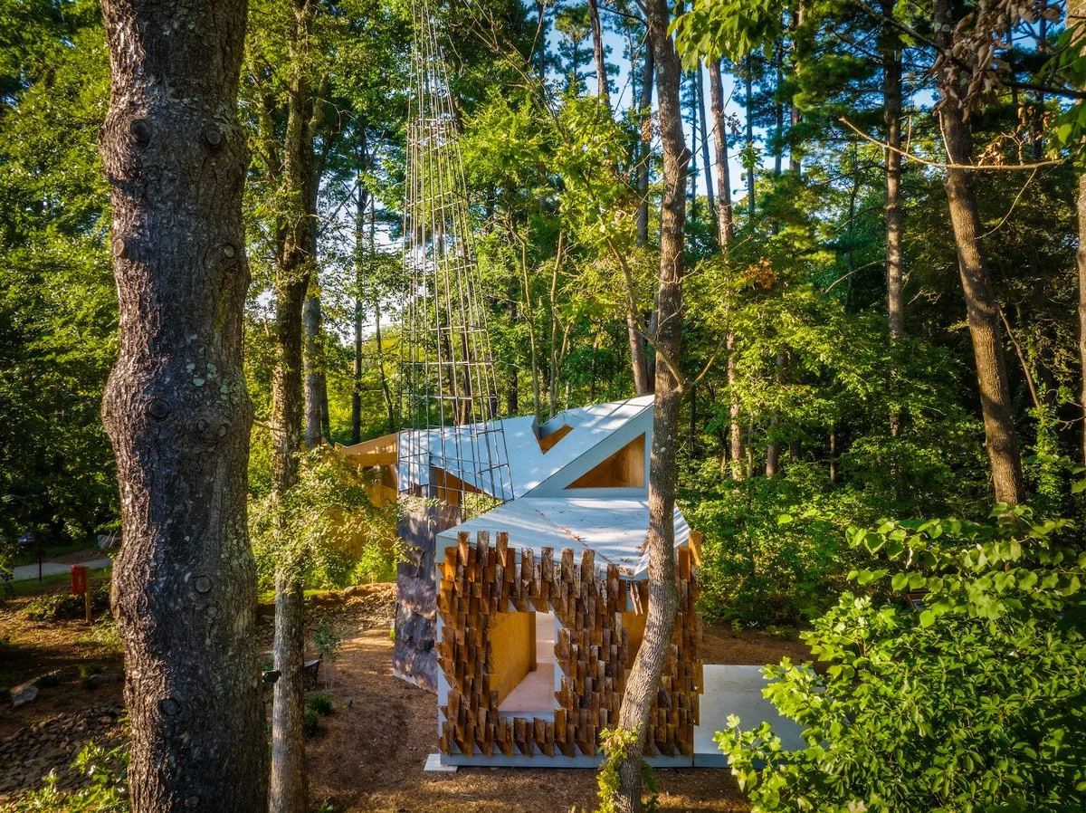 Sculptural, expressive architectural follie designed by studio:indigenous integrated into a deep, sun drenched forest.