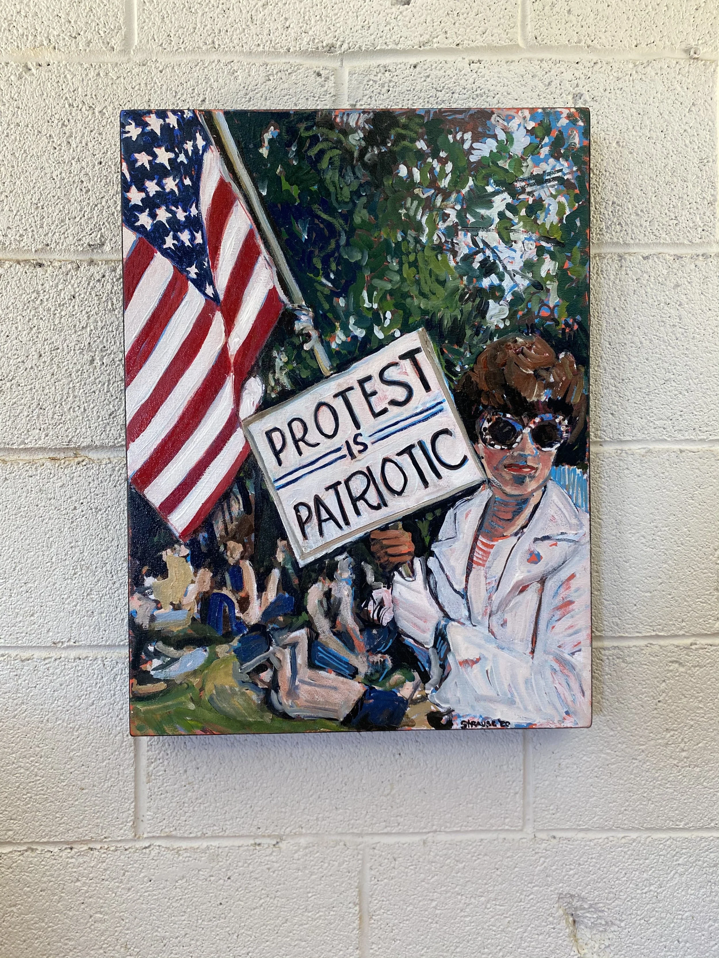 Painted artwork of a young girl in a patriotic theme, holding an American flag and a sign that reads 'PROTEST IS TRICKY PATRIOTIC', with green foliage in the background.