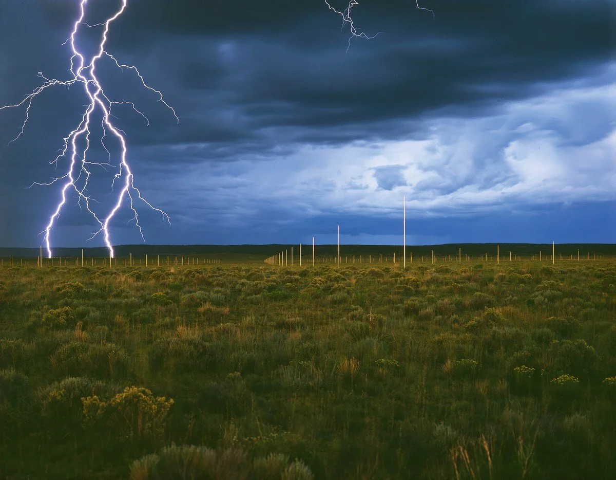 Metal rods rise out of the New Mexican desert, lightning strikes them, clouds roll in.