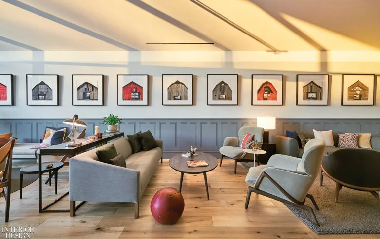 Sunset filled lounge at a club, contemporary wainscoting, george dombeck colorful barns framed in a row, contemporary soft seating in a light wide plank white oak flooring.