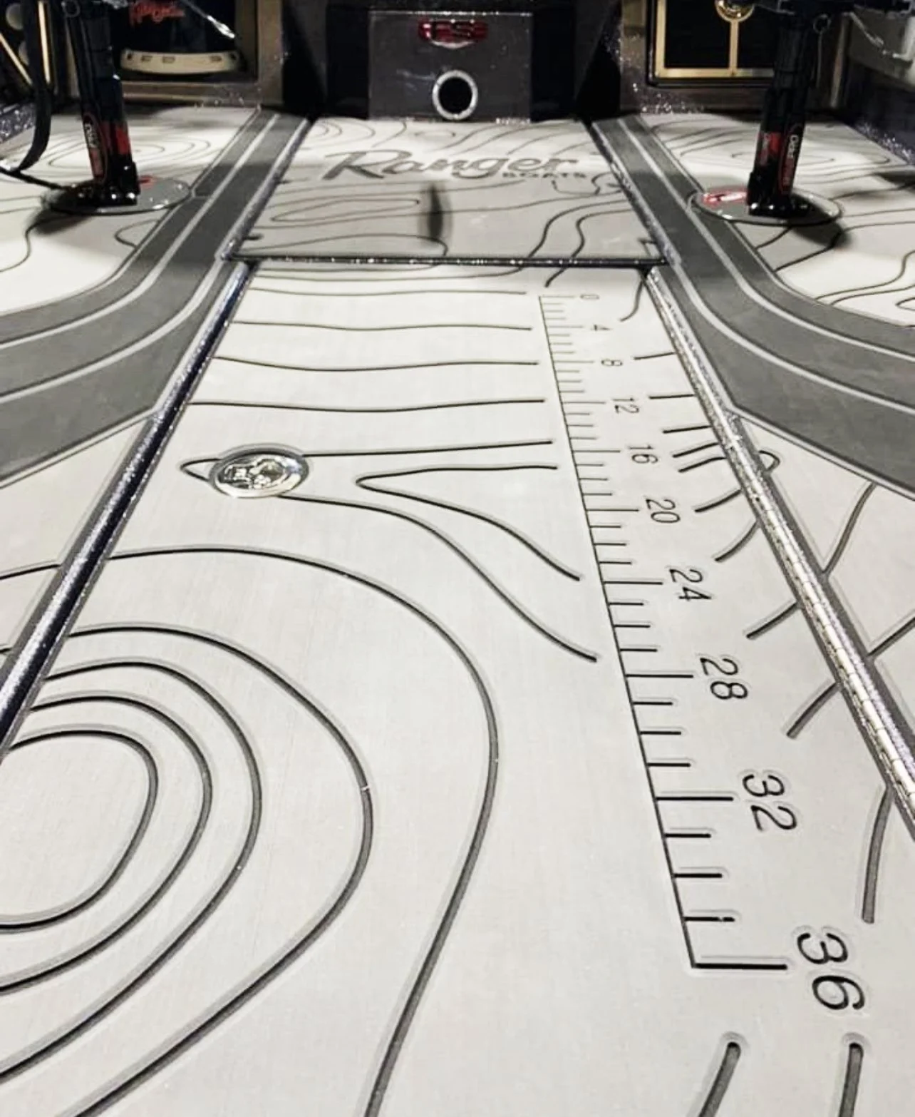Pinball machine with a terrain-themed playfield, including roads, a ruler for measurement, and a mountain design.