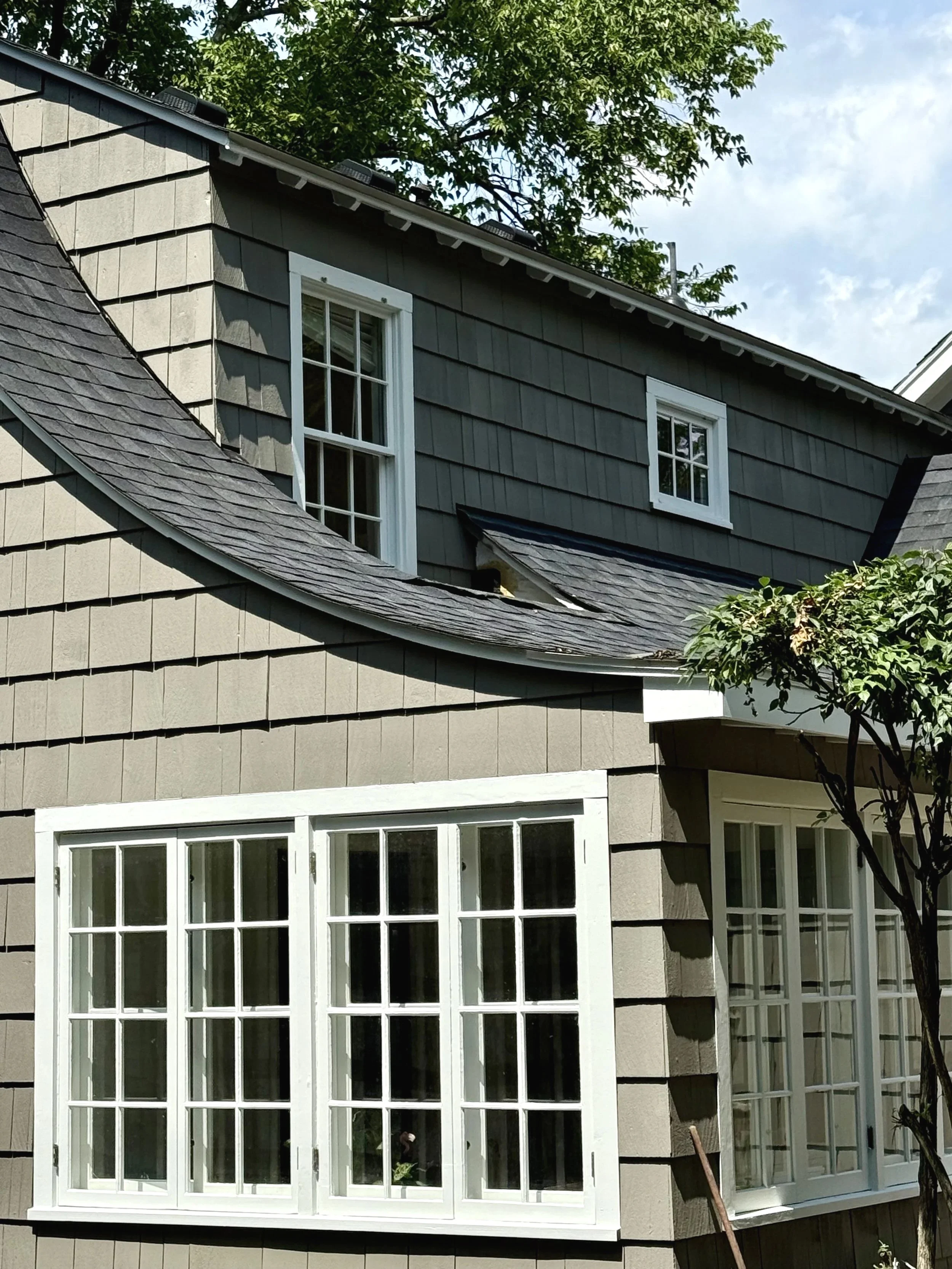 Exterior house painting in Columbus Ohio with painted siding, white trim, and detailed finish by professional painting company