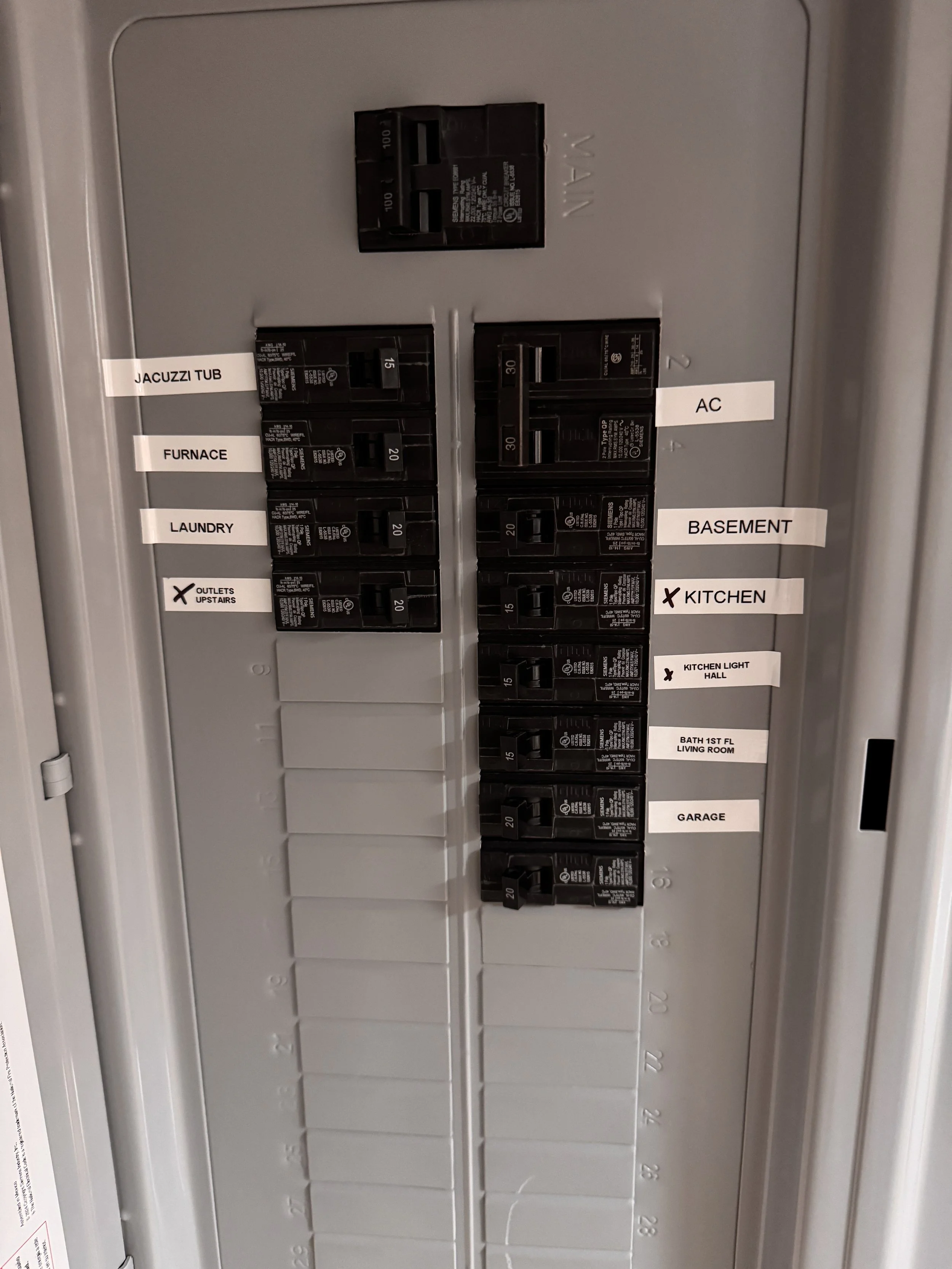 Circuit breaker box with labeled switches for Jacuzzi tub, furnace, laundry, AC, basement, kitchen, kitchen light hall, bath 1st floor living room, and garage.