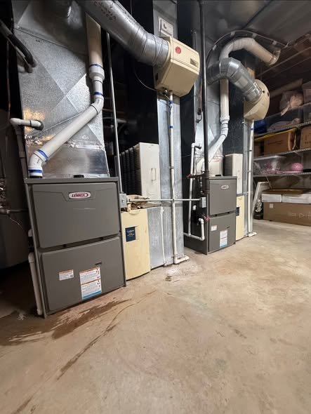 Close-up of HVAC and ductwork in a basement or utility room.