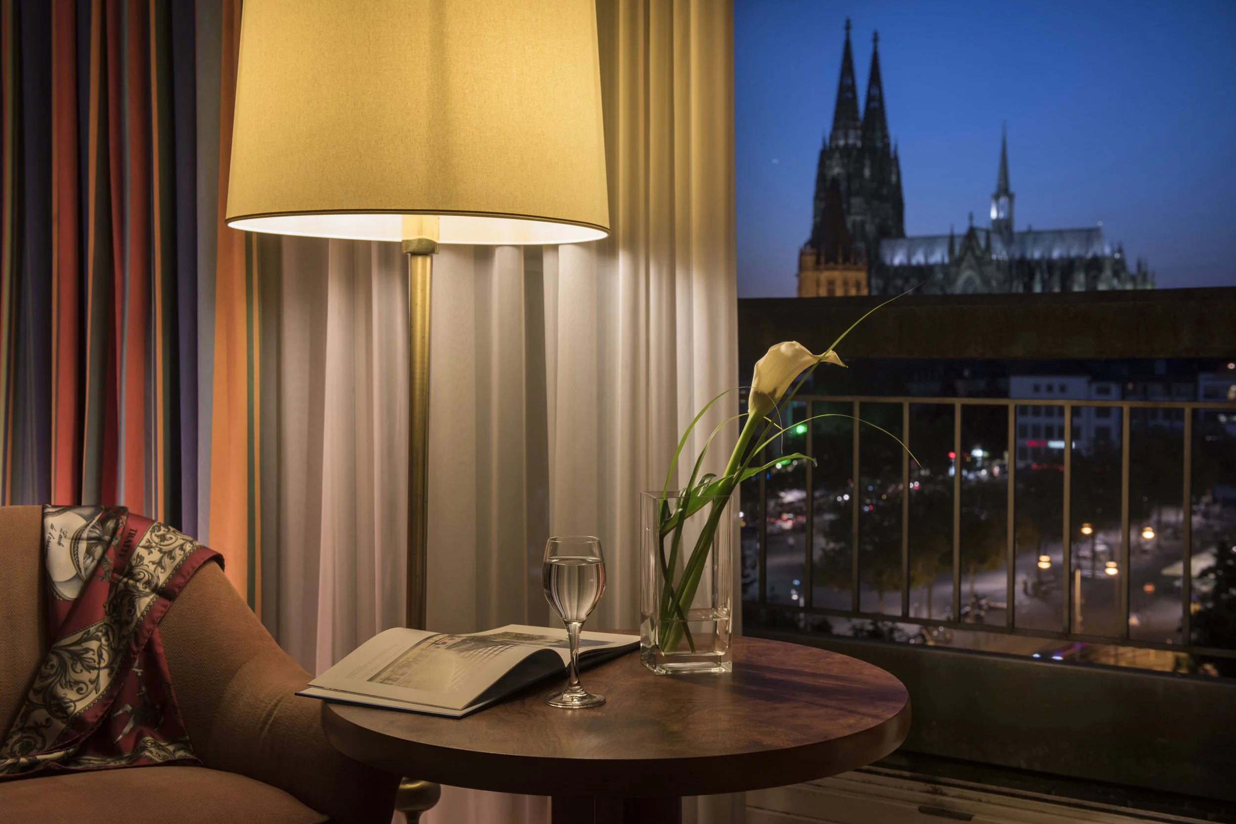 Maritim Hotel Koln guest room window overlooking cathedral in the evening.