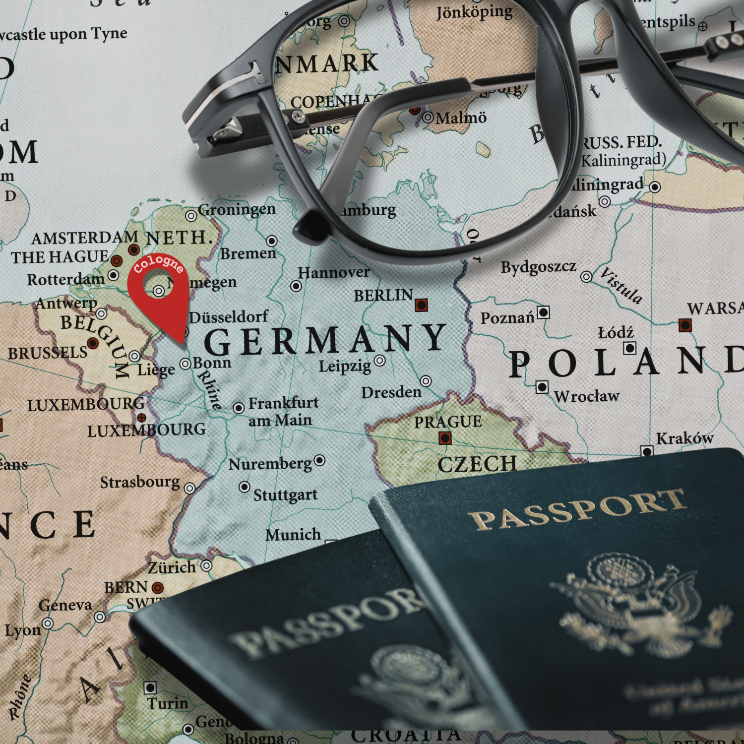 German map with passport and glasses