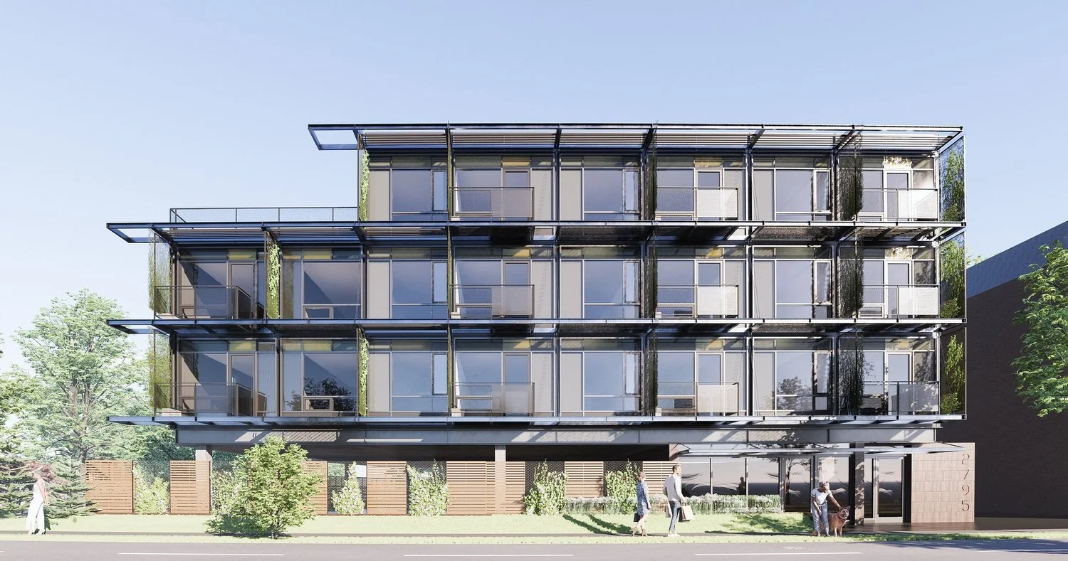 Modern four-story apartment building with glass balconies, greenery, and a glass entrance on a city street.