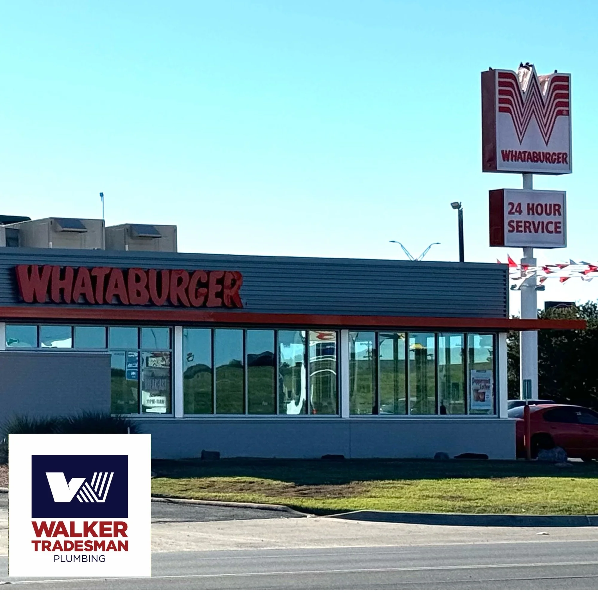 A Whataburger fast food restaurant with a large sign on a pole showing the logo and '24 HOUR SERVICE'. The restaurant has glass windows and a red and gray exterior. There is a car parked at the side and a sidewalk in front.
