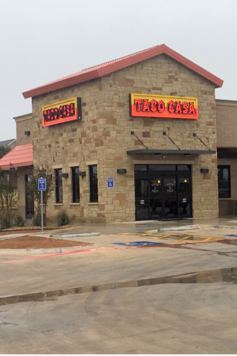 Taco Casa building in a parking lot on a rainy day.