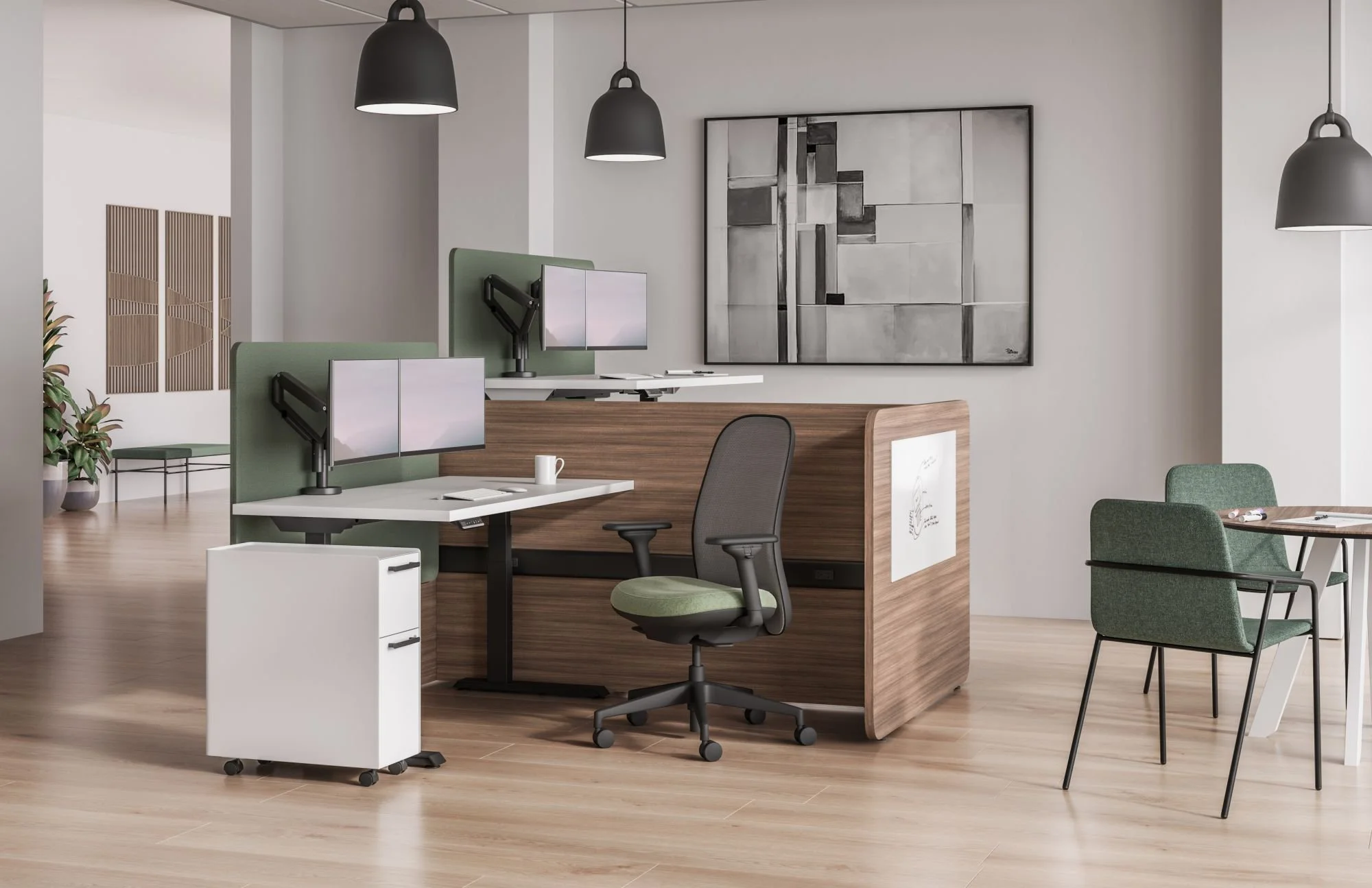 Modern office with workstations, a large abstract black and white painting on the wall, hanging black pendant lights, and indoor plants.