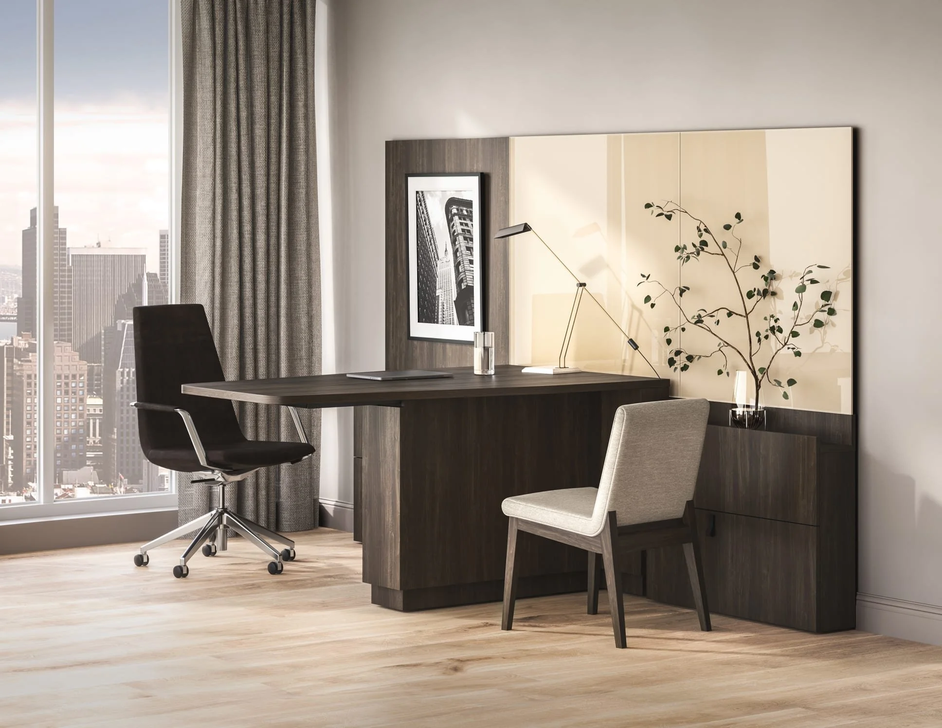 Modern office space with a desk, black and gray chairs, a tall window with city skyline view, gray curtains, a wall art photograph, a desk lamp, and a decorative branch in a vase.