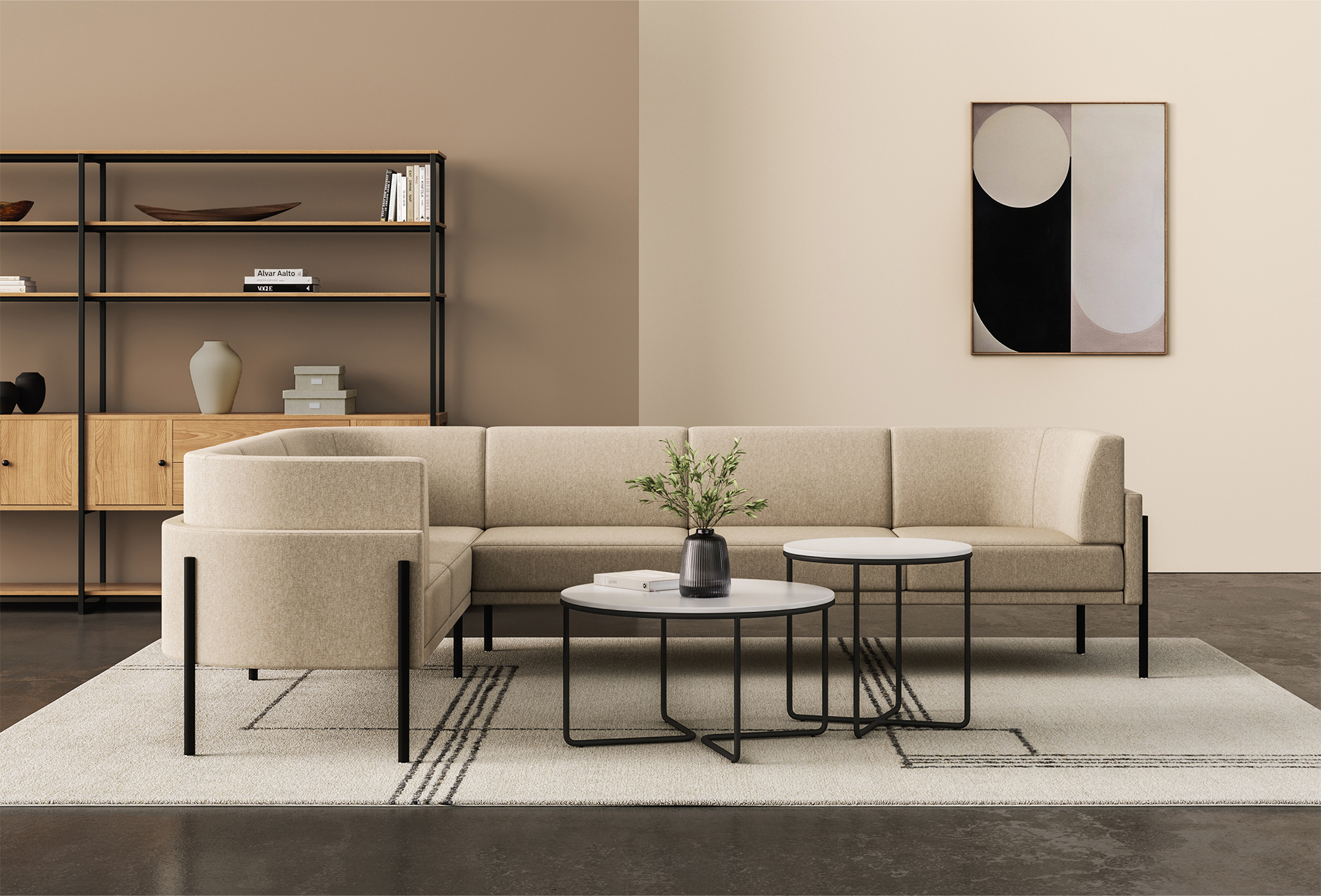 Modern living room with beige sofa, black coffee tables, and a bookcase with decorative items and books, a potted plant on one table, an abstract art piece on the wall, on a beige rug on a dark floor.