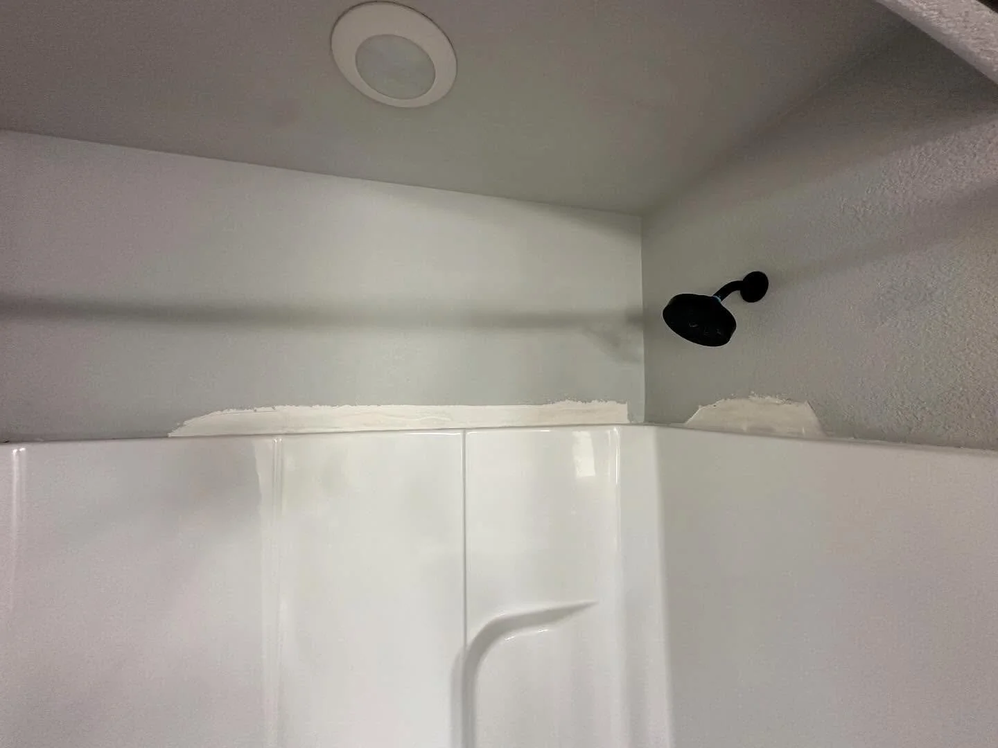 Quick little drywall fix above this shower surround