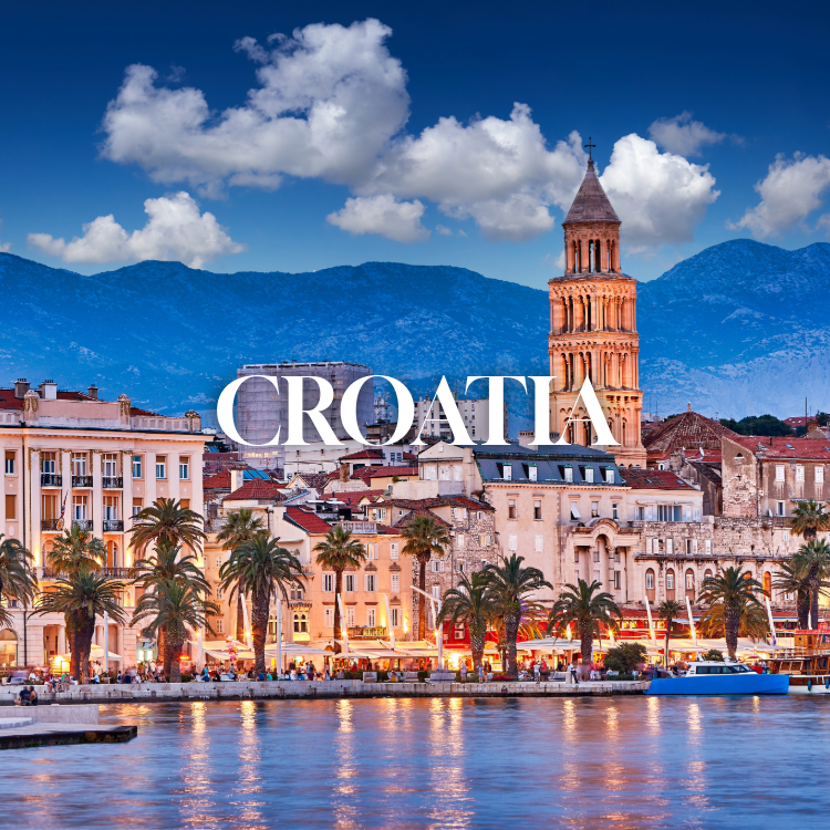 View of a Croatian seaside city with palm trees, historic buildings, a church bell tower, mountains in the background, and a waterfront with boats and promenade.