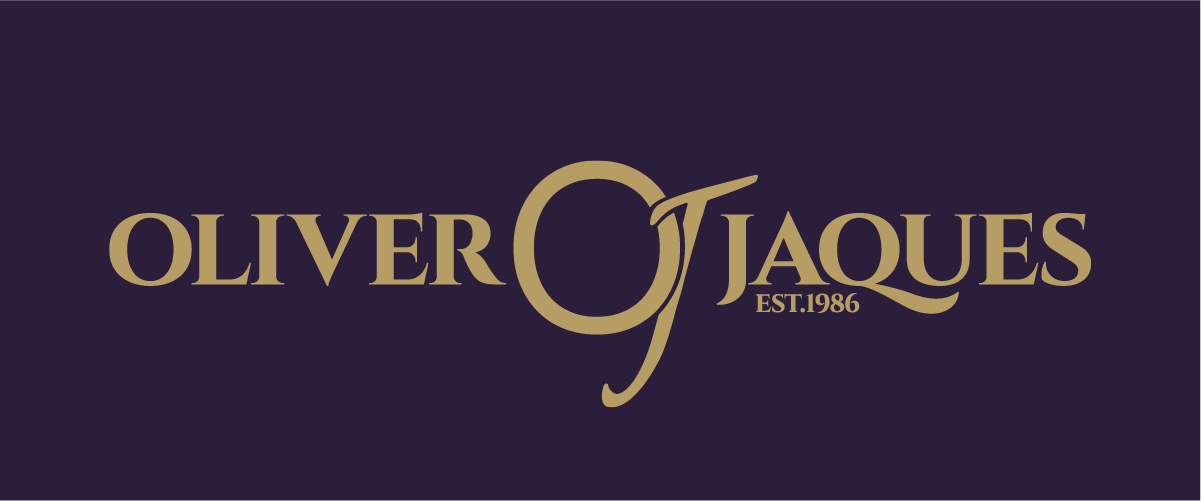 Brand logo for Oliver Jaques with gold text on a dark background, including the establishment year 1986.