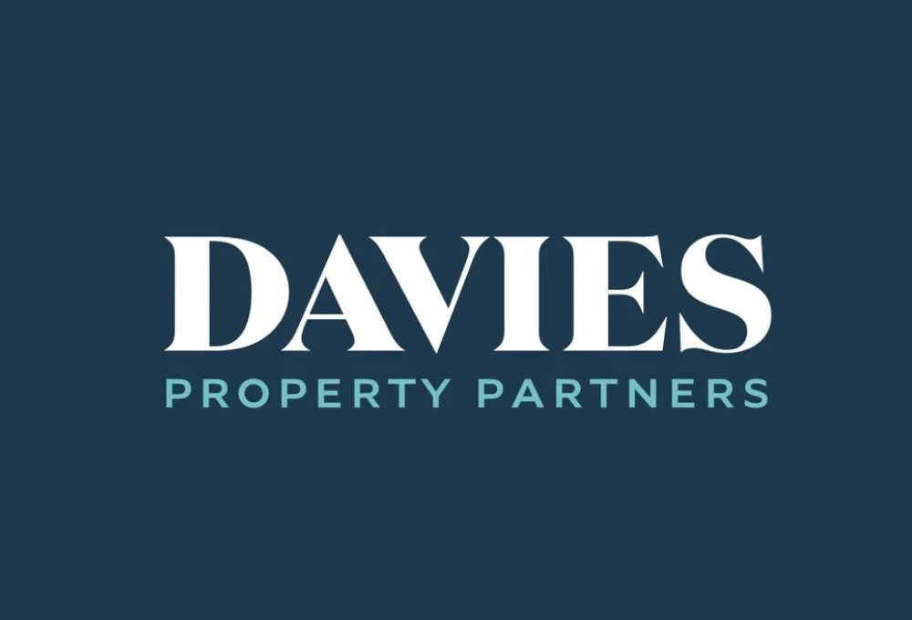 Logo for Davies Property Partners, with the company name in large white letters and the tagline in smaller blue letters on a dark blue background.