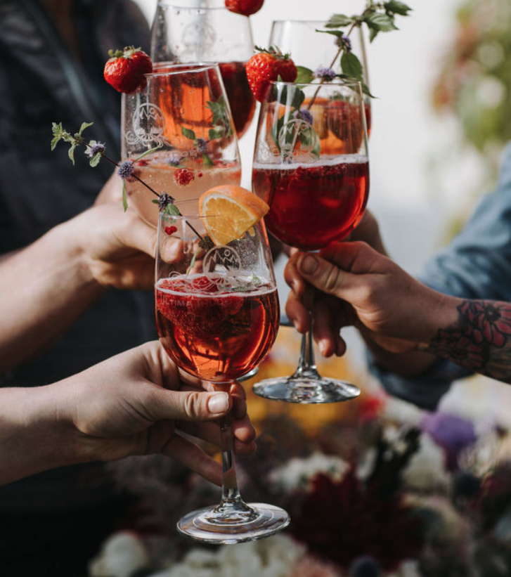 Craft cocktails from The Hall at our Alaskan wilderness lodge in McCarthy—pink spritzes with strawberry and citrus.