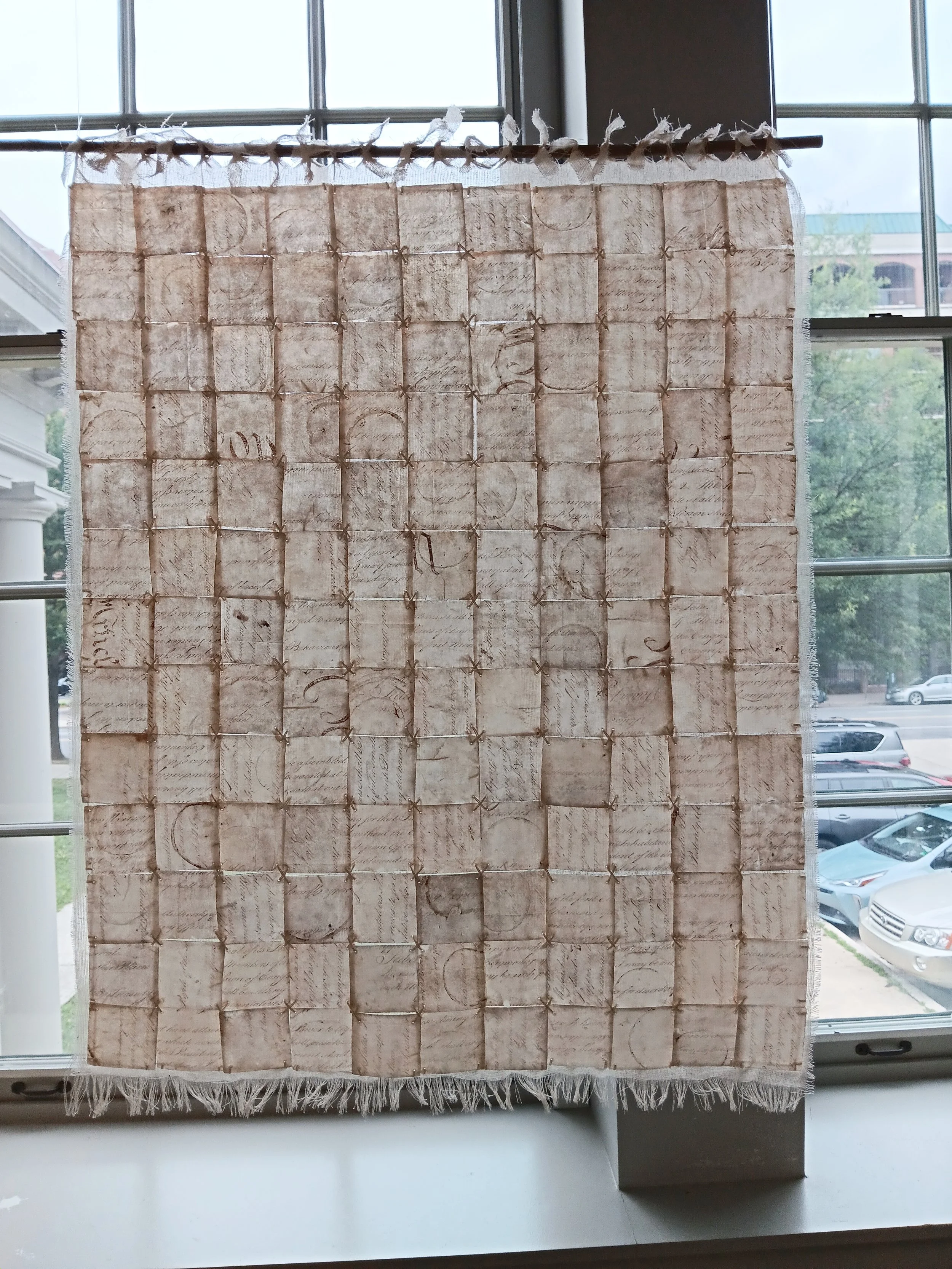 Liberté, Égalité, Fragilité (Page I). 2026; capiz, image transfer, cotton scrim, silk embroidery thread; 26"h x 22"w.