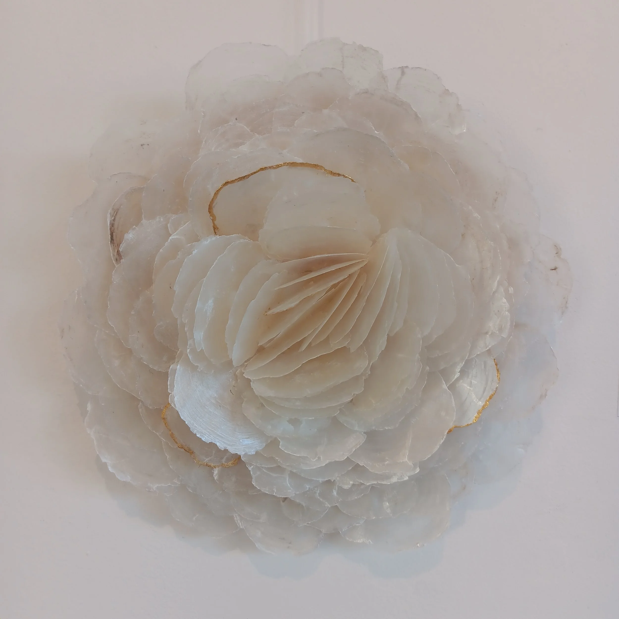 A Body Made of Breakers I. 2025; capiz shells, birch panel, genuine gold leaf; 14.5"h x 14"w x 4"d.