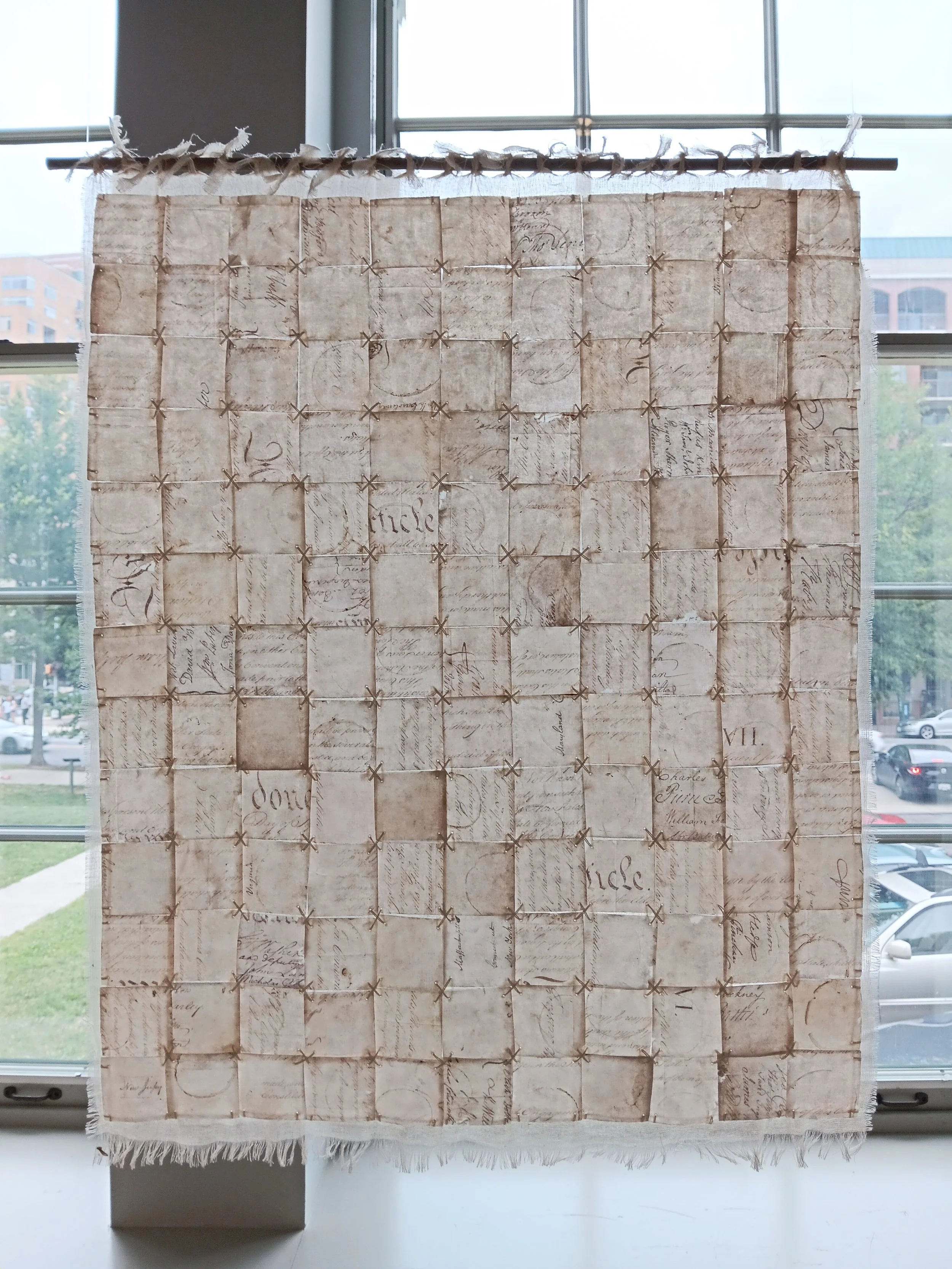 Liberté, Égalité, Fragilité (Page IV). 2026; capiz, image transfer, cotton scrim, silk embroidery thread; 26"h x 22"w.