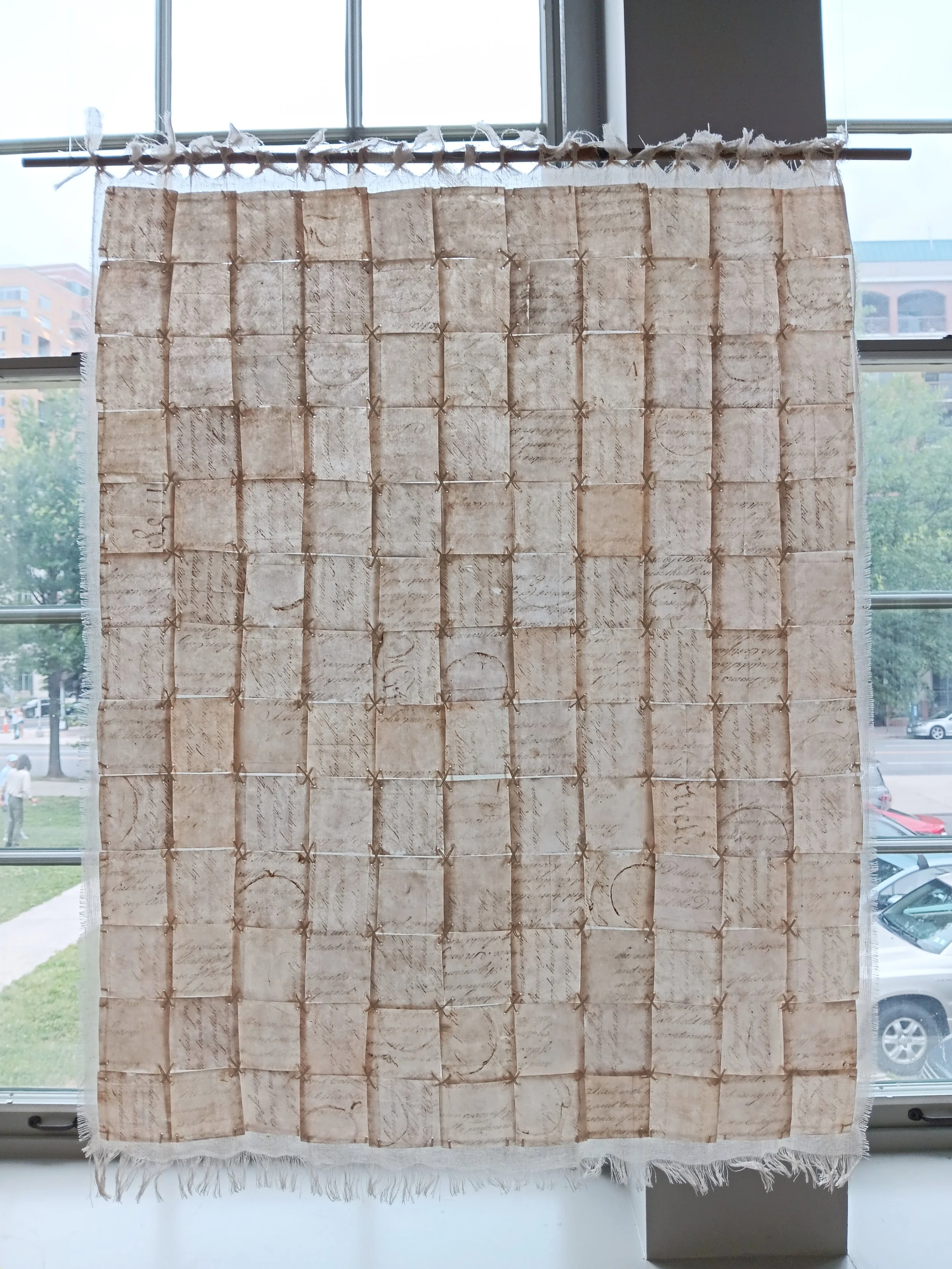 Liberté, Égalité, Fragilité (Page III). 2026; capiz, image transfer, cotton scrim, silk embroidery thread; 26"h x 22"w.