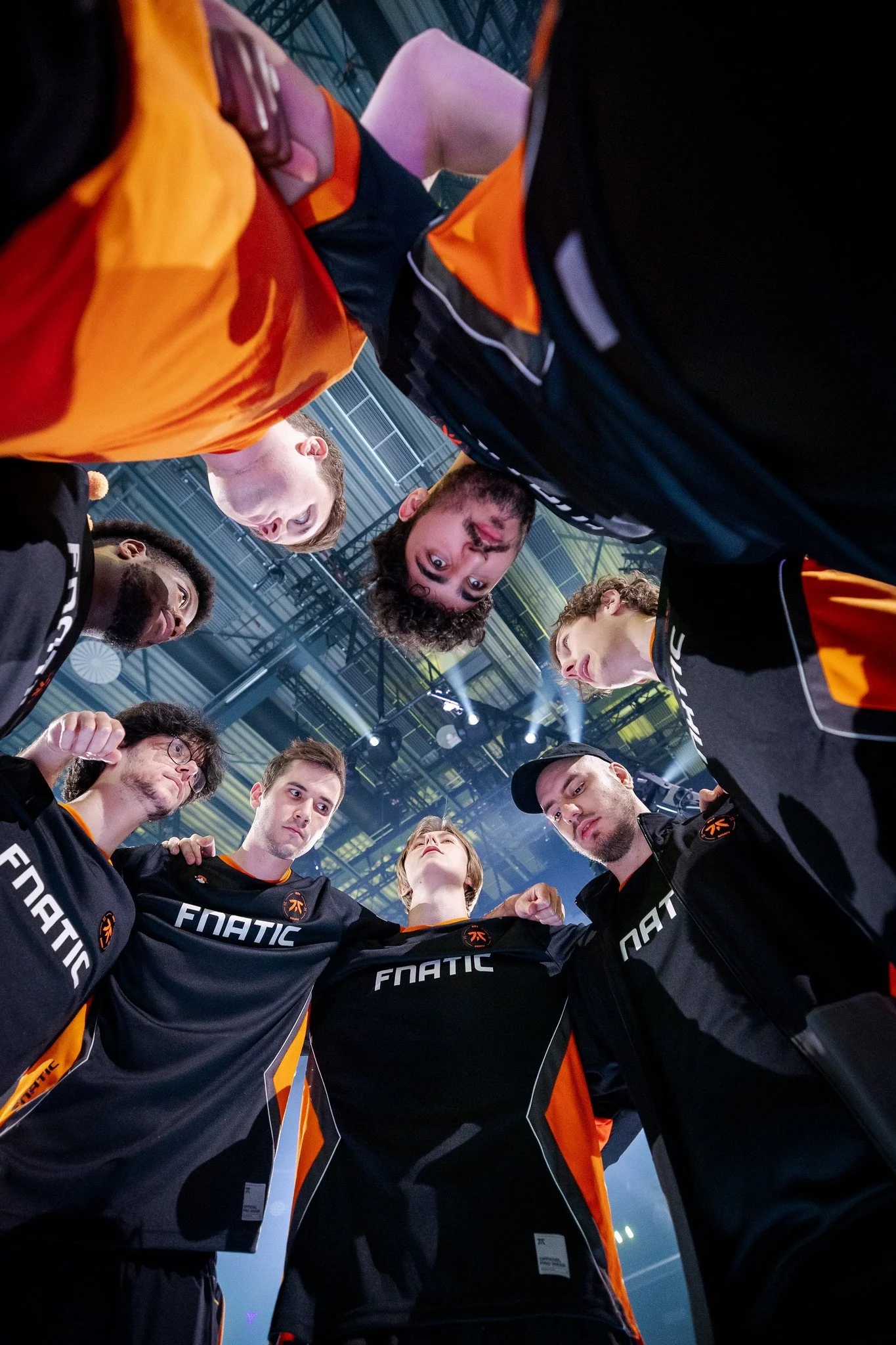 A group photo of a team huddle with all members looking at the captain during a team talk before a competition