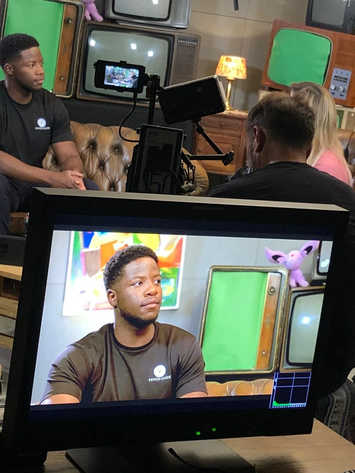 Black performance psychologist on a studio set answering questions about how to manage stress, emotions and perform with confidence