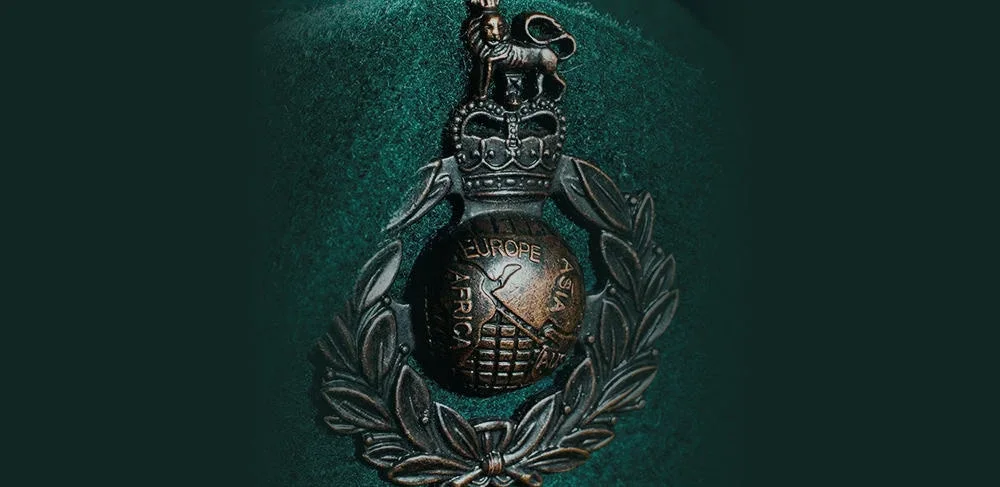 A military medal with a crown at the top, surrounded by a laurel wreath, featuring a globe with the words "Europe, Asia, Africa, American" and a sword.