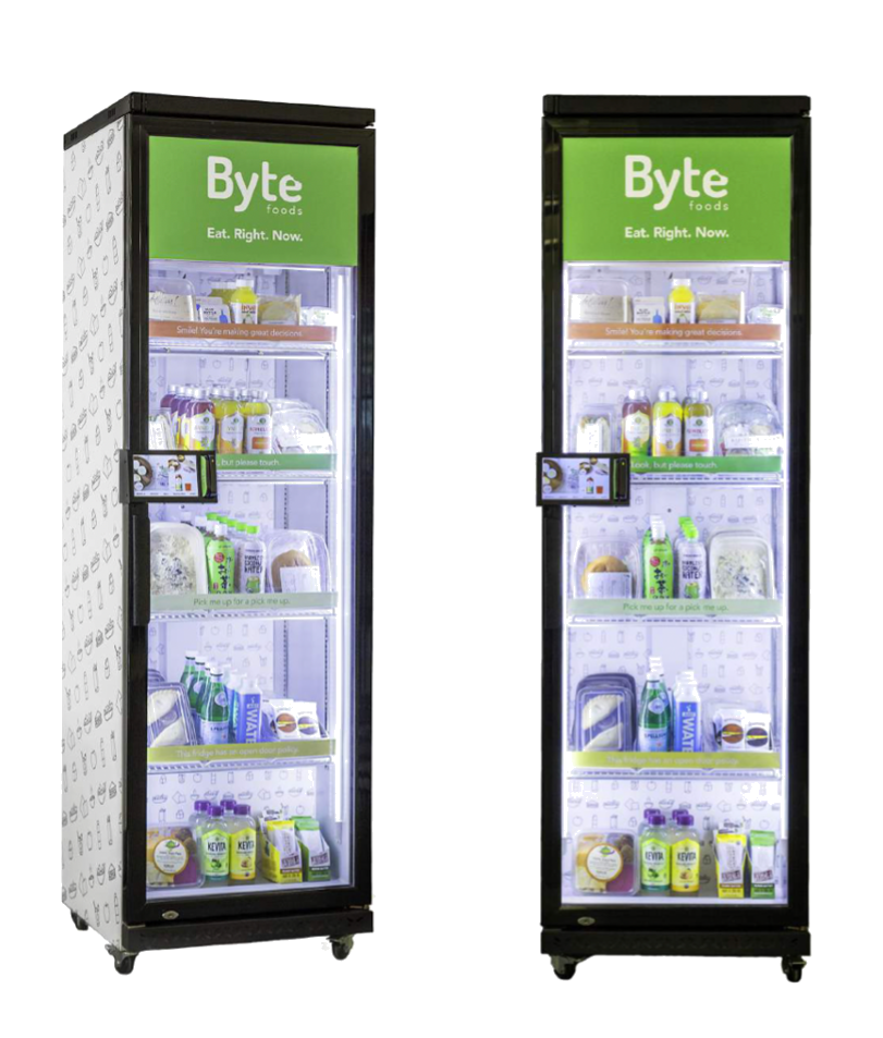 Two upright smart vending solutions with transparent doors selling organic and natural food products.