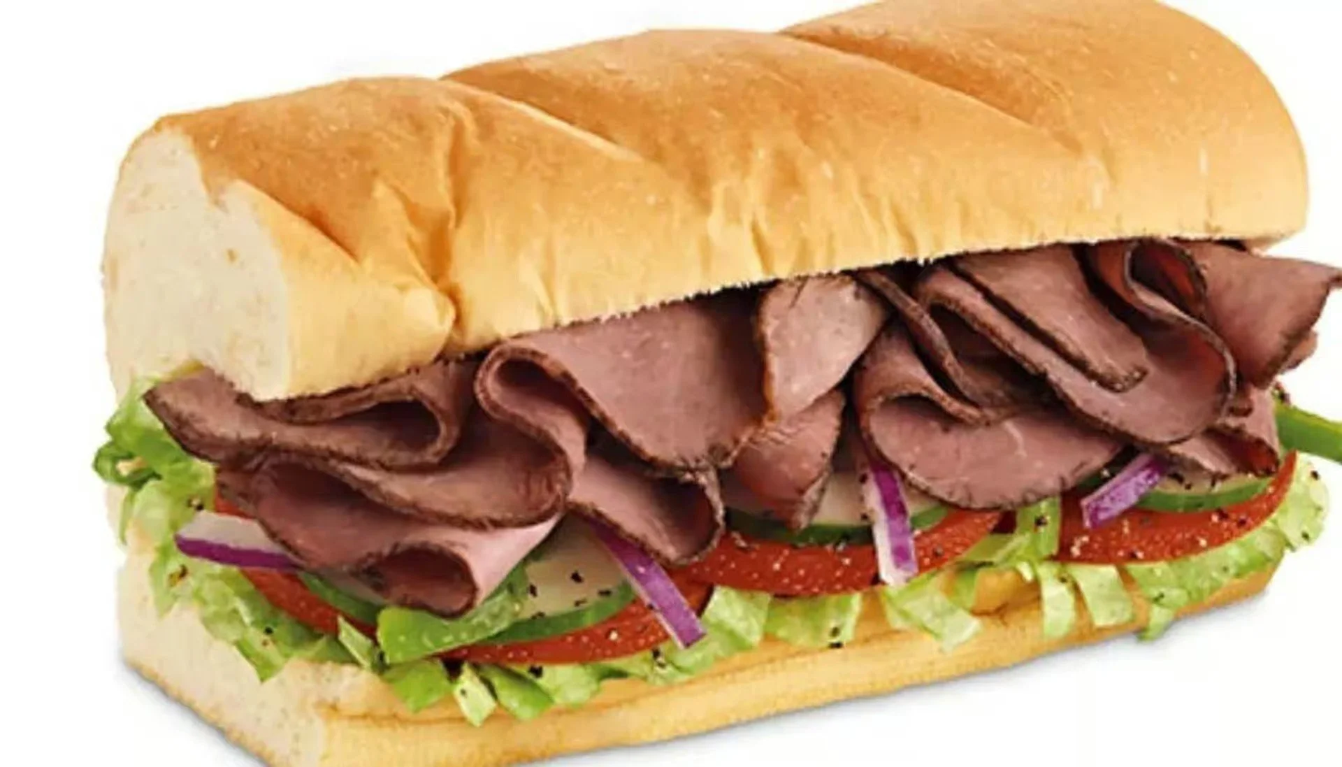A beef sandwich with sliced roast beef, lettuce, tomato, red onion, and cucumbers in a hoagie bun.