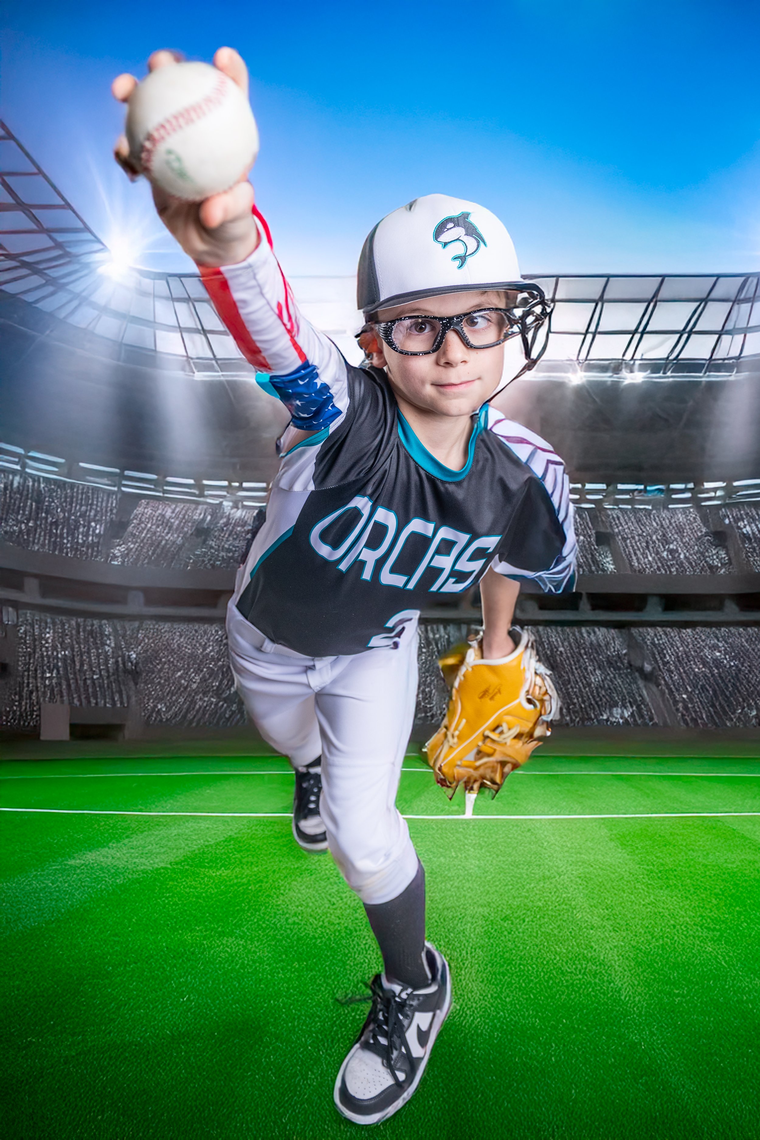 Young boy in baseball uniform, wearing a cap, glasses, and holding a baseball, running on a green field with a stadium background.