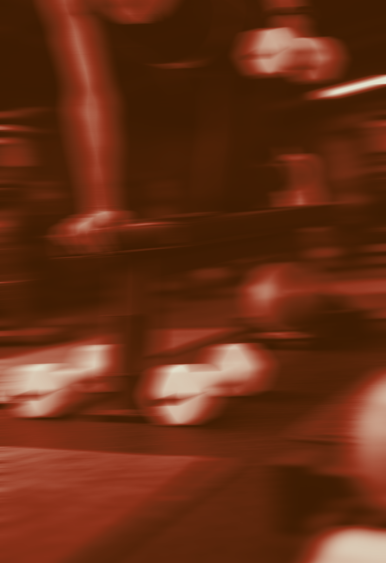 A blurry, reddish-brown photo that appears to show a metallic object or surface with reflective highlights and some abstract shapes.