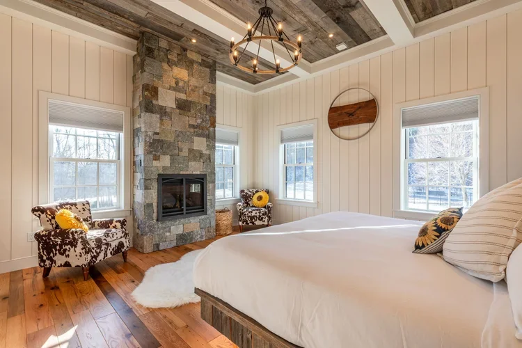 Beautifully painted and renovated bedroom with a gas fireplace.