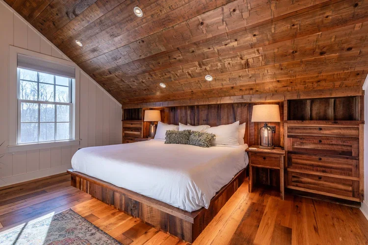 Distressed wood ceiling accent in bedroom.